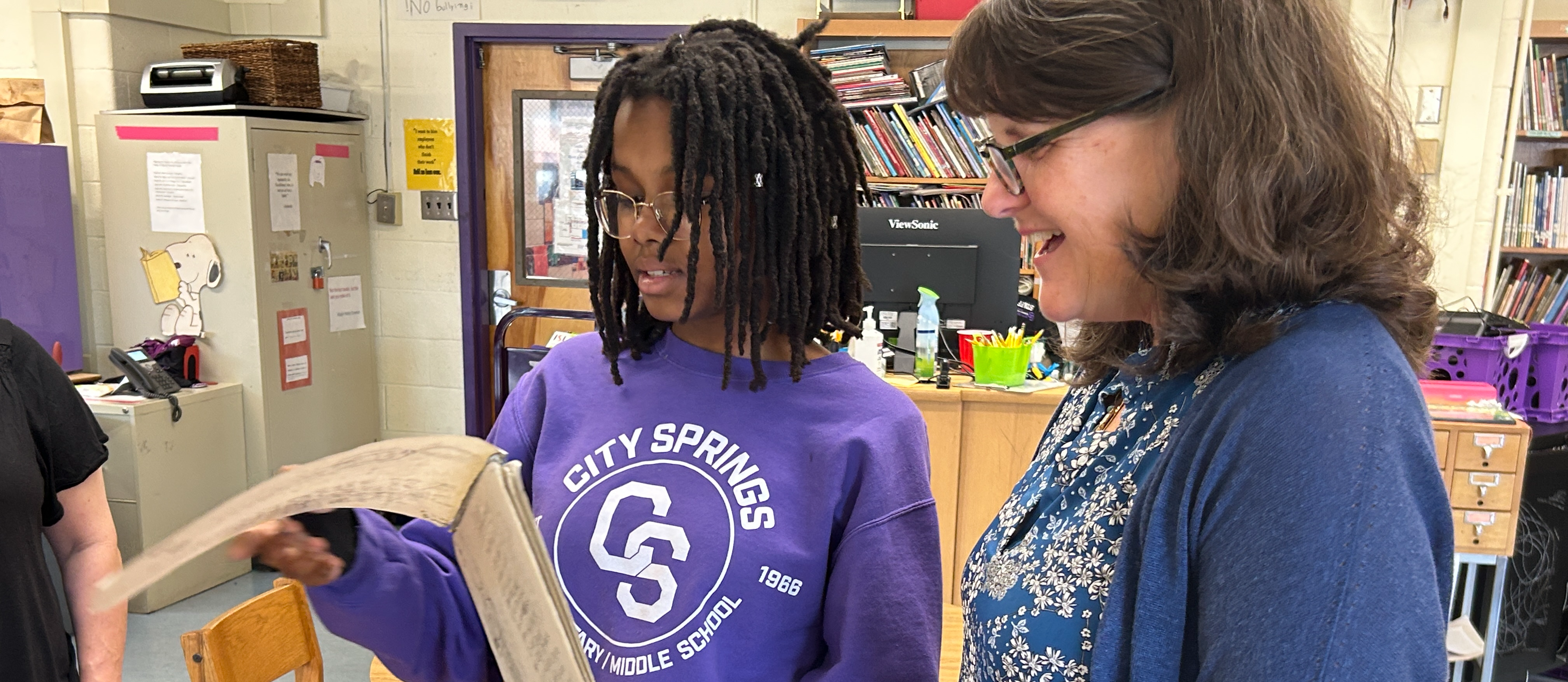 Author Kate Messner reads a piece from one of the City Springs students involved in a writing workshop. 