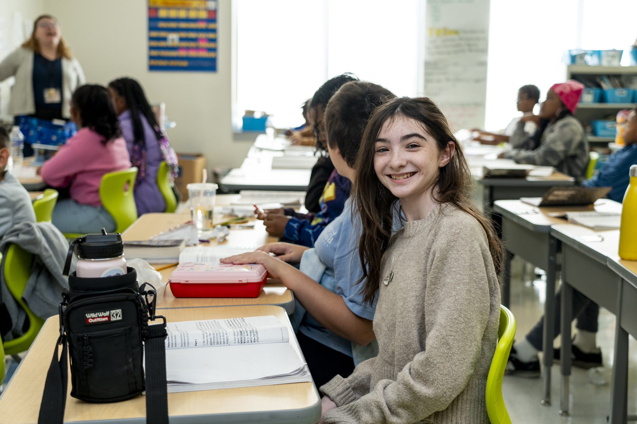 Medfield Heights student smiles at the camera while in class