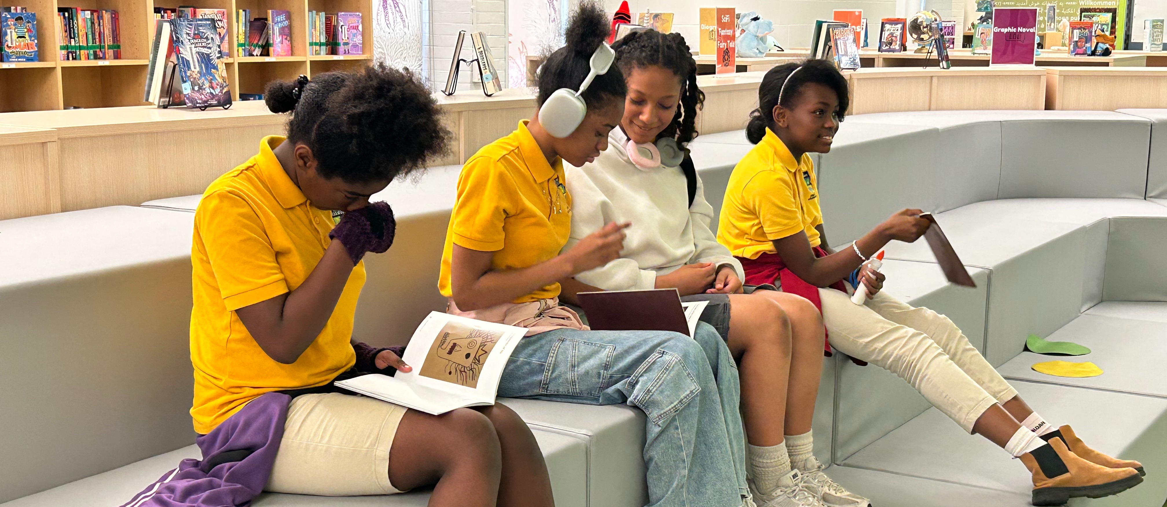 KIPP students sit and review the literary magazine they created 