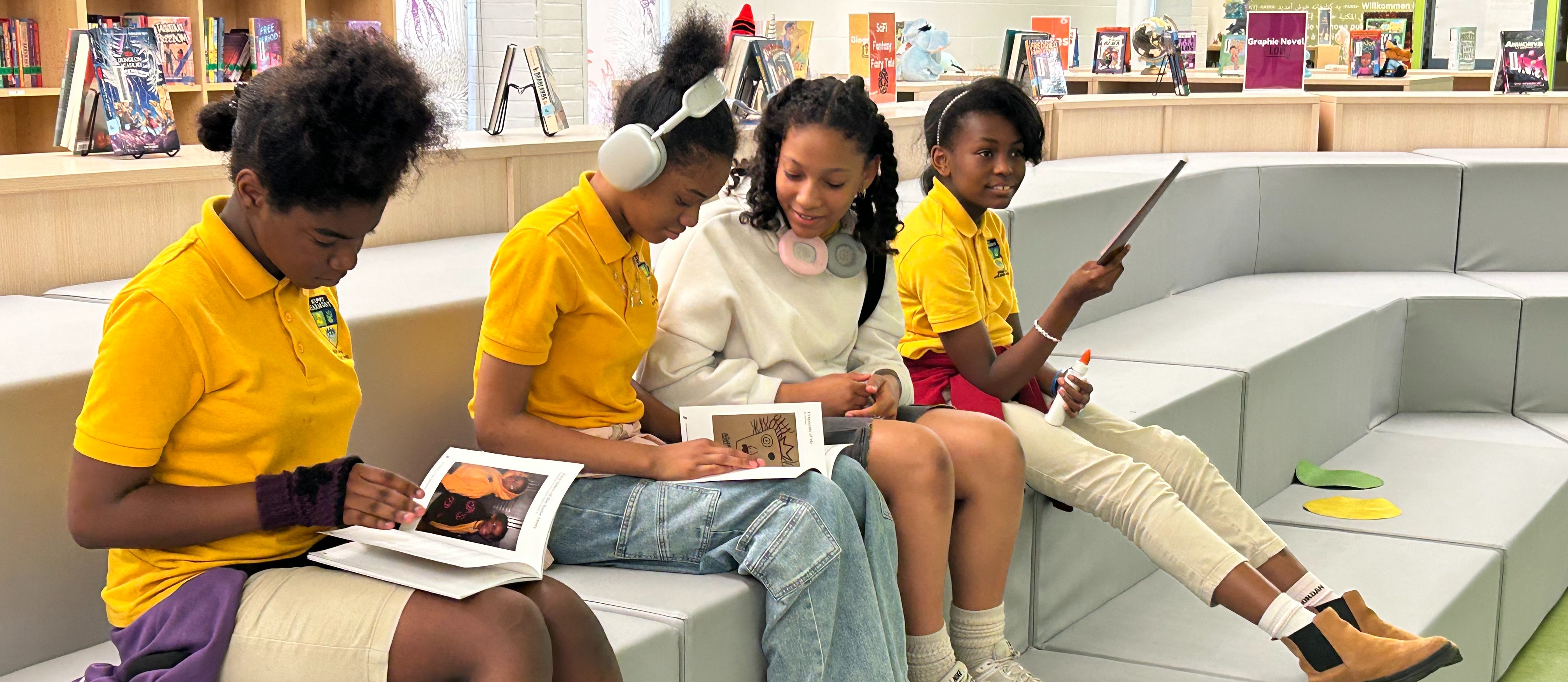 KIPP students sit and review the literary magazine they created 