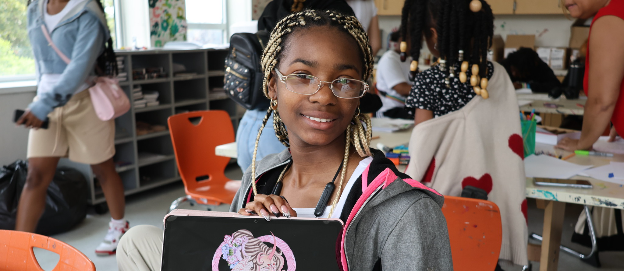Amiyah poses with the graphic art created at Summer Camp.