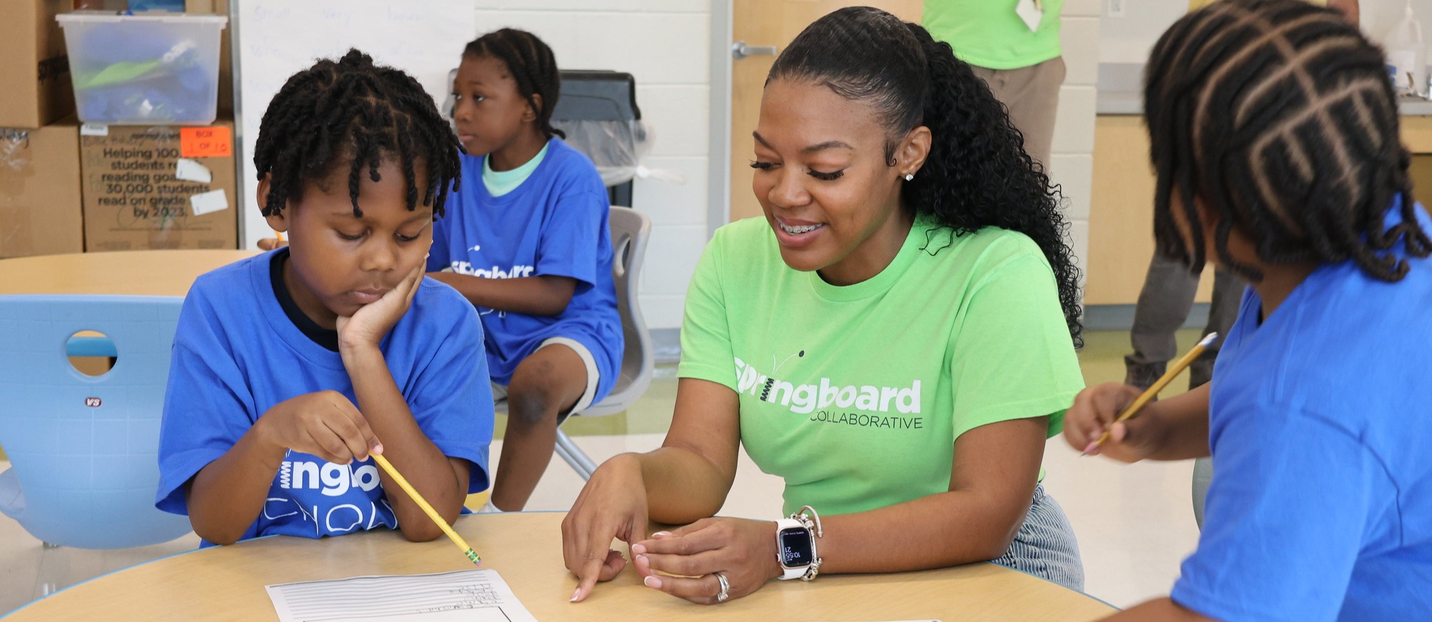 Springboard staff assists students with a writing exercise. 