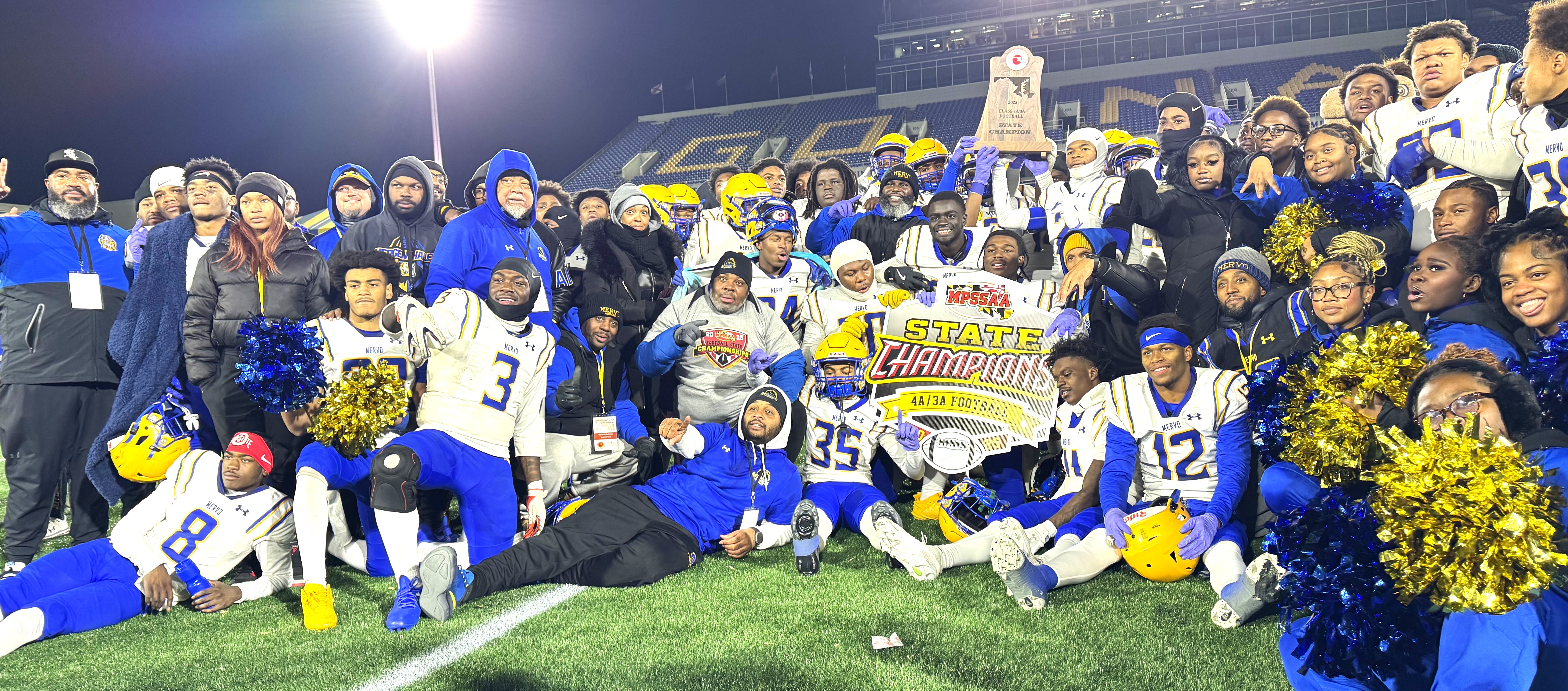 Mervo, your Class 4A/3A State Champs football team poses for a photo on the football field after their win. 