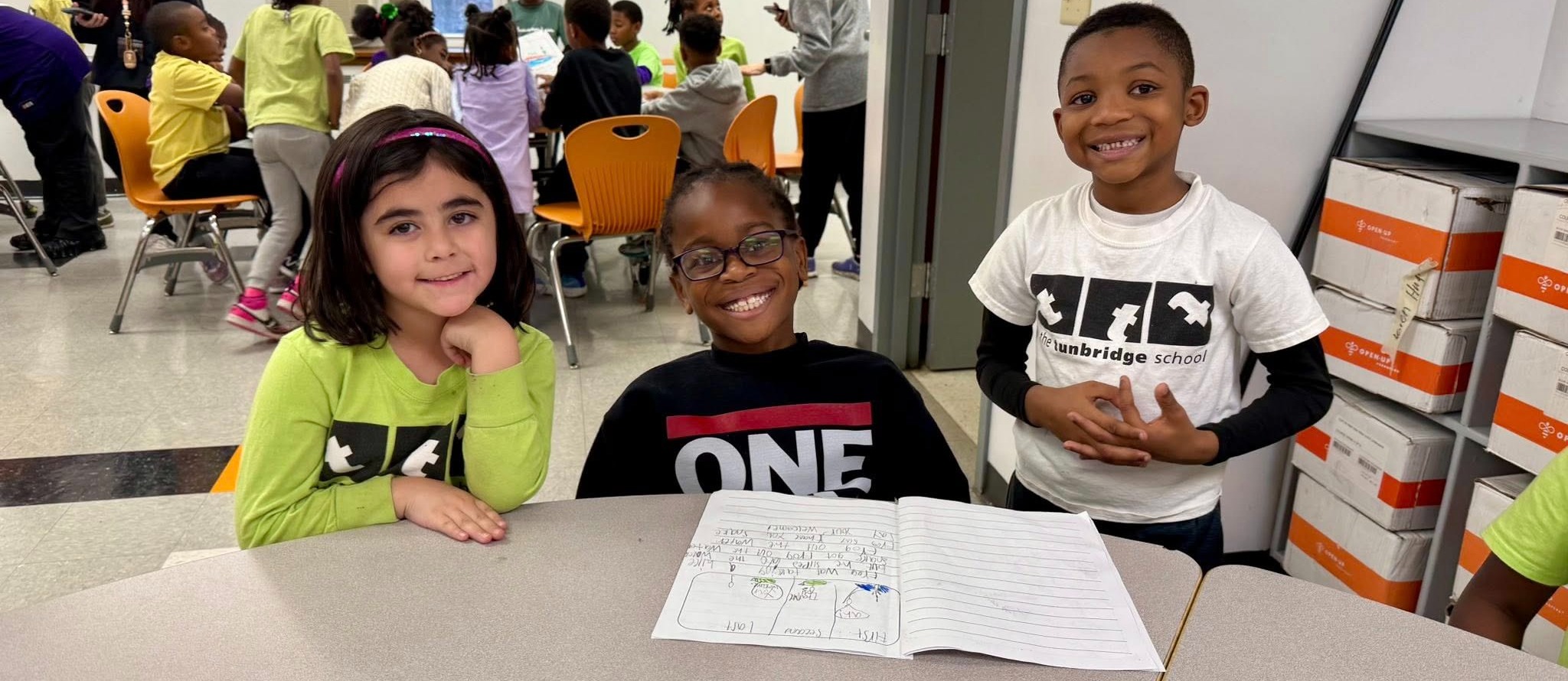 Students smile and hug each other