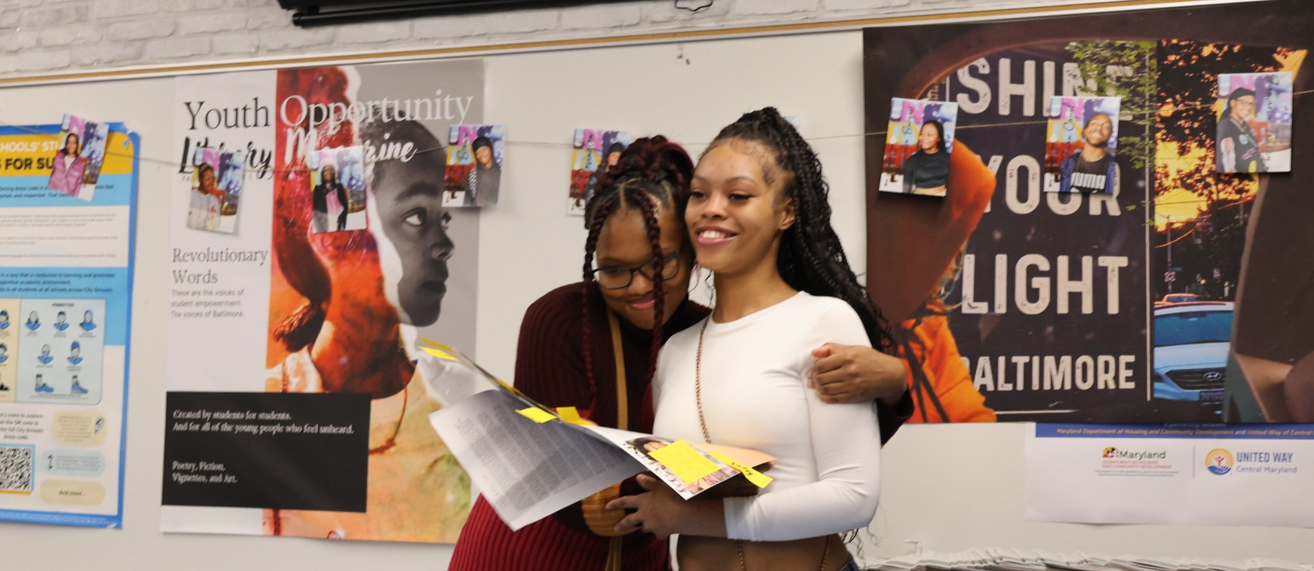 Two high school students hugging