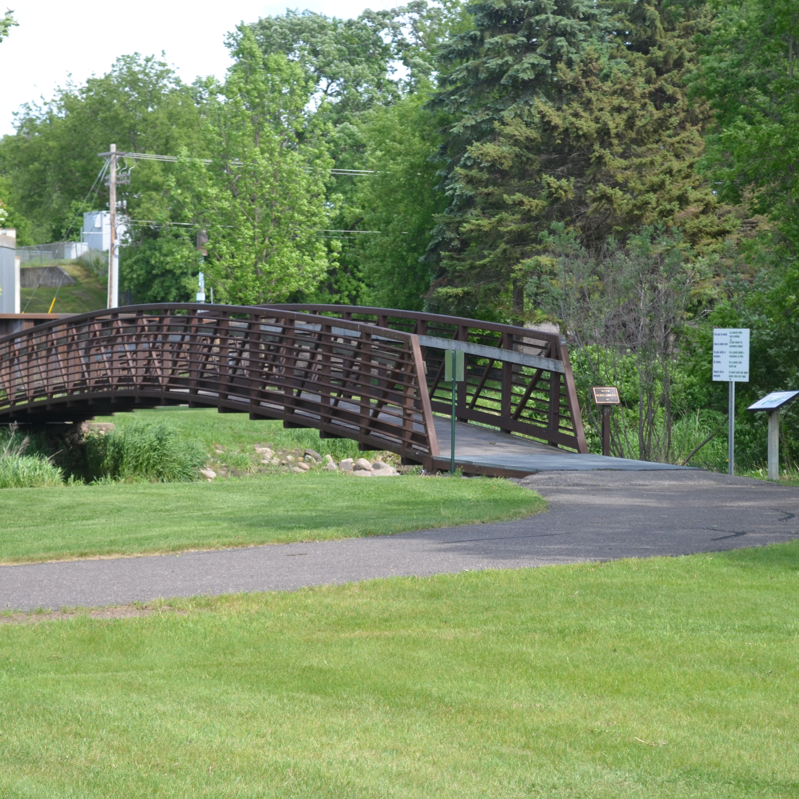 a bridge with a lot of green trees around it