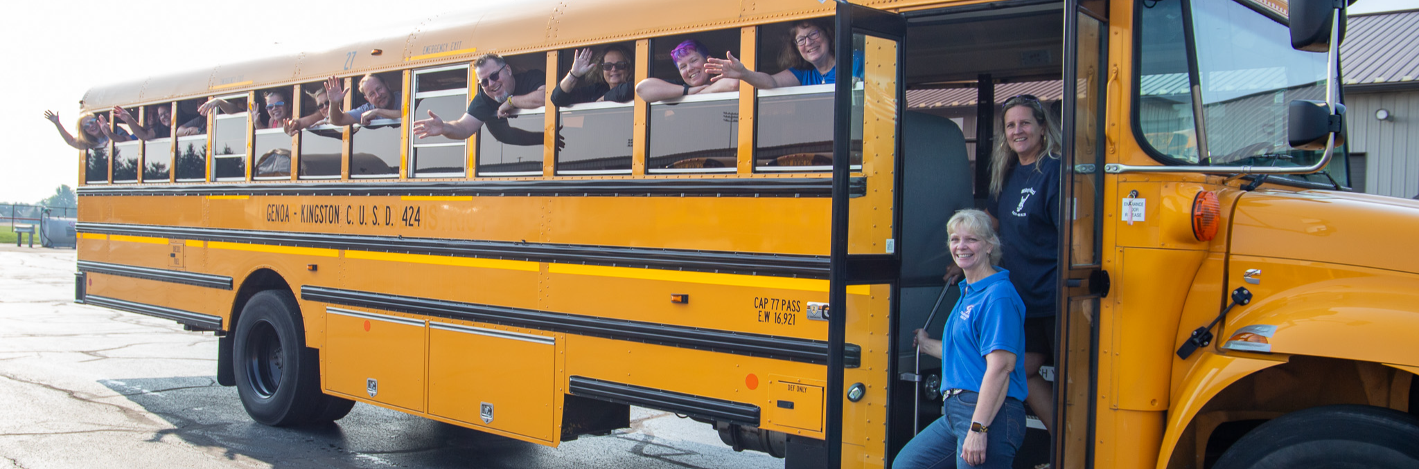 image of transportation staff waving at camera from bus