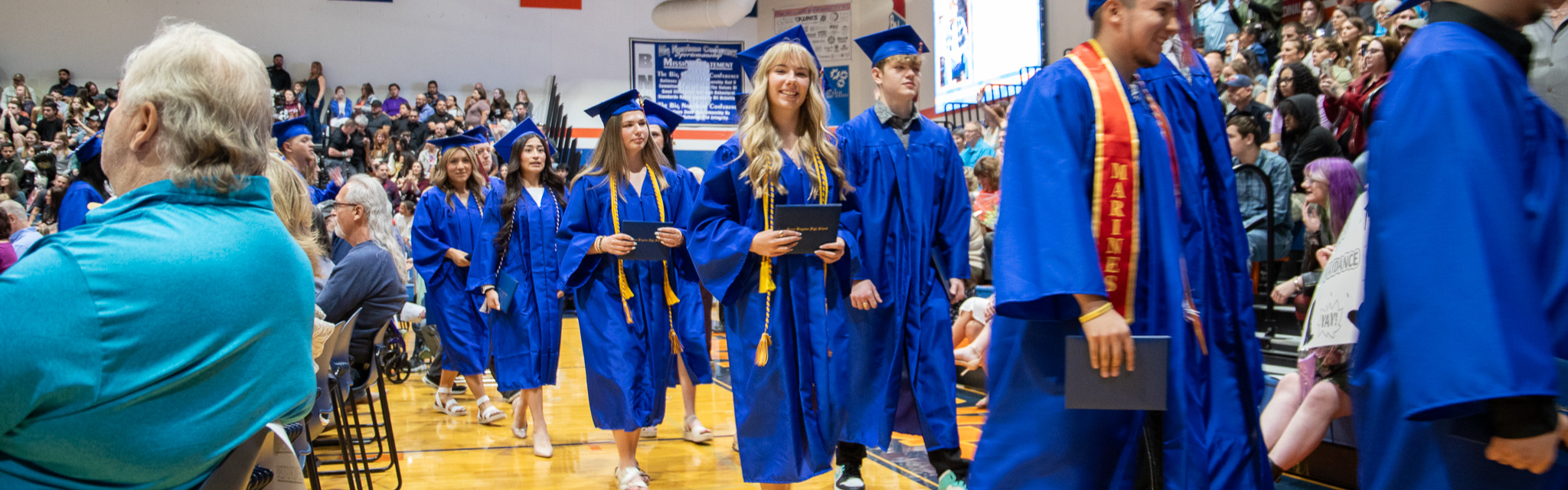 students walking at graduation