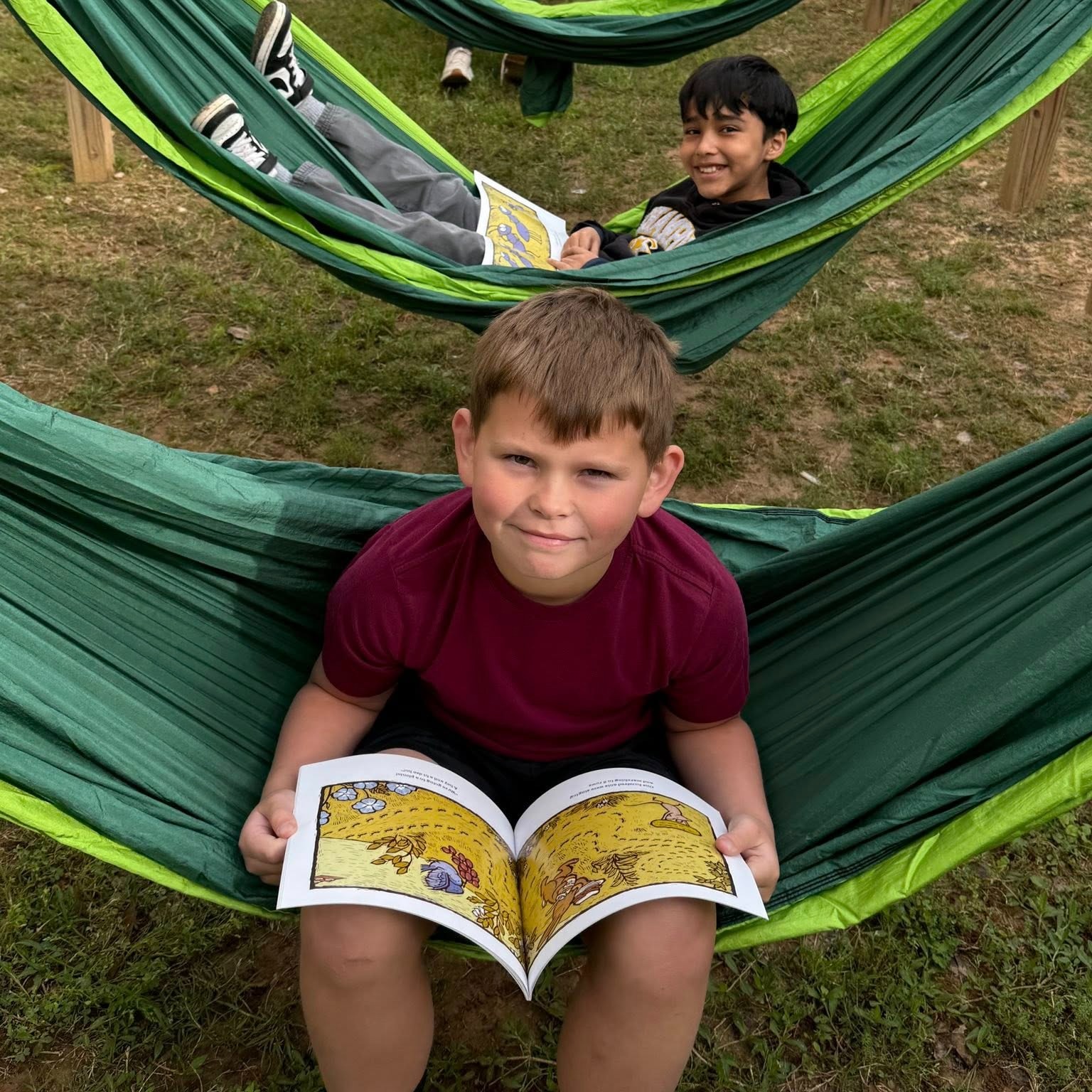 boys in reading hammocks with books