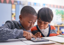 Students working together on a tablet