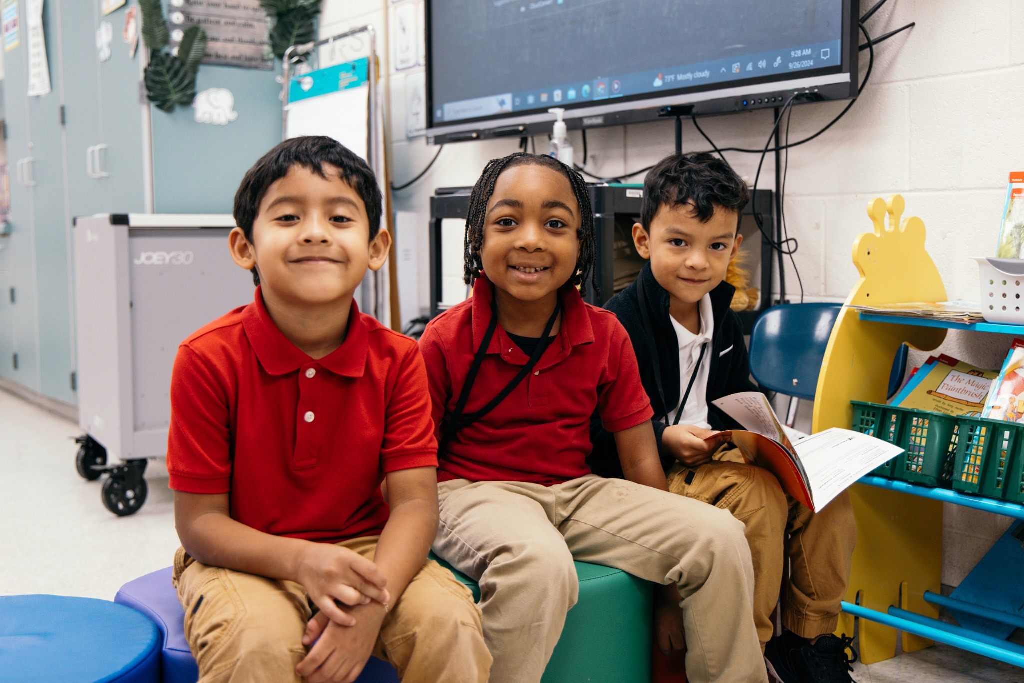 3 male students siting and smiling. 
