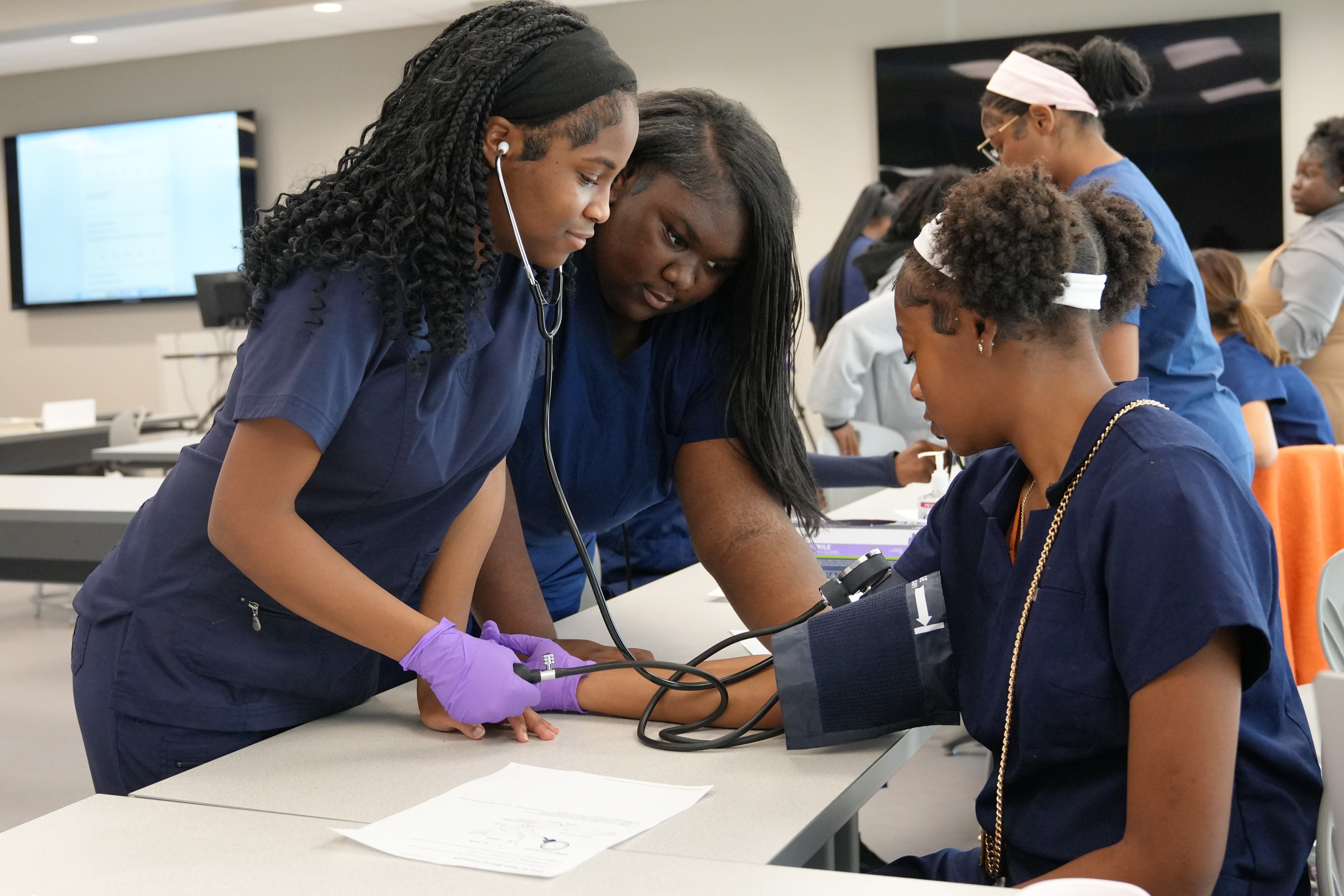 CTE students with blood pressure cuff