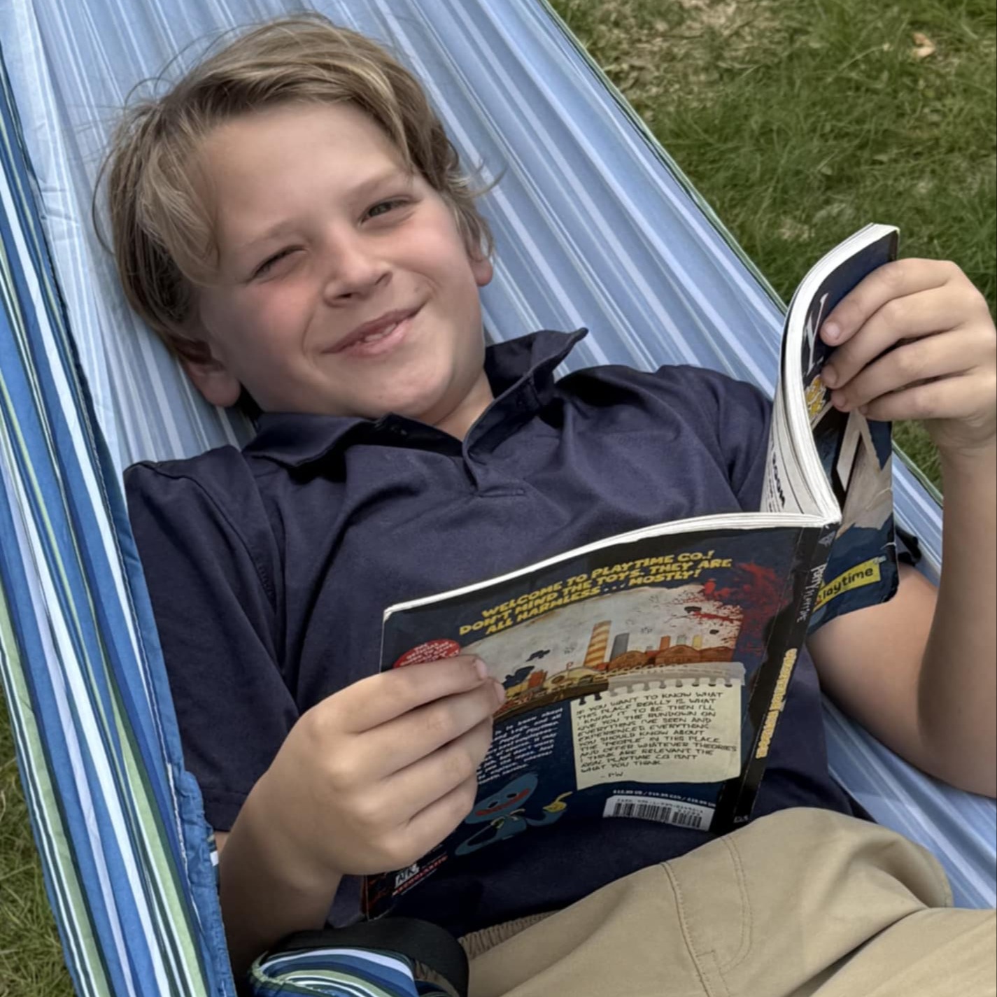 student reads book in hammock