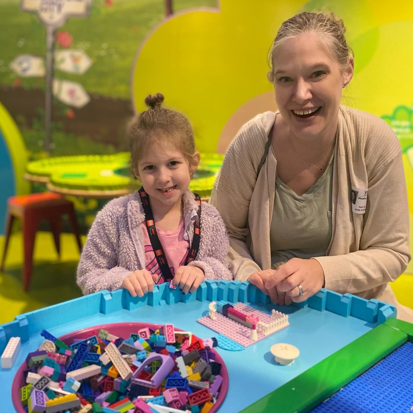 teacher and student play at lego land