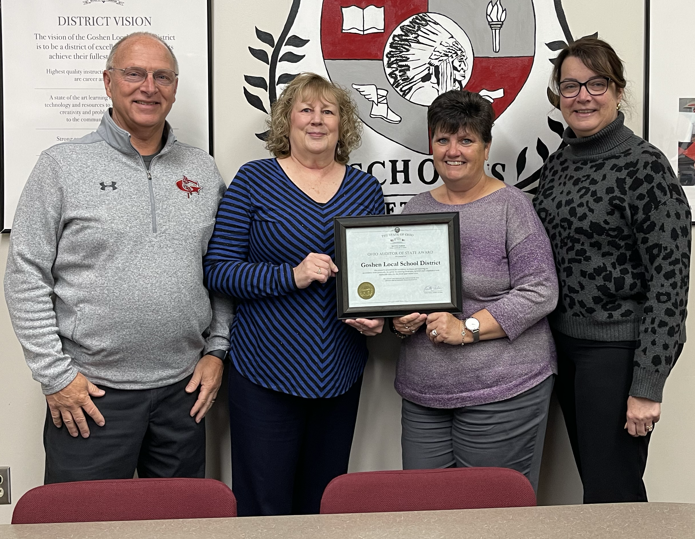 Staff members holding certificate