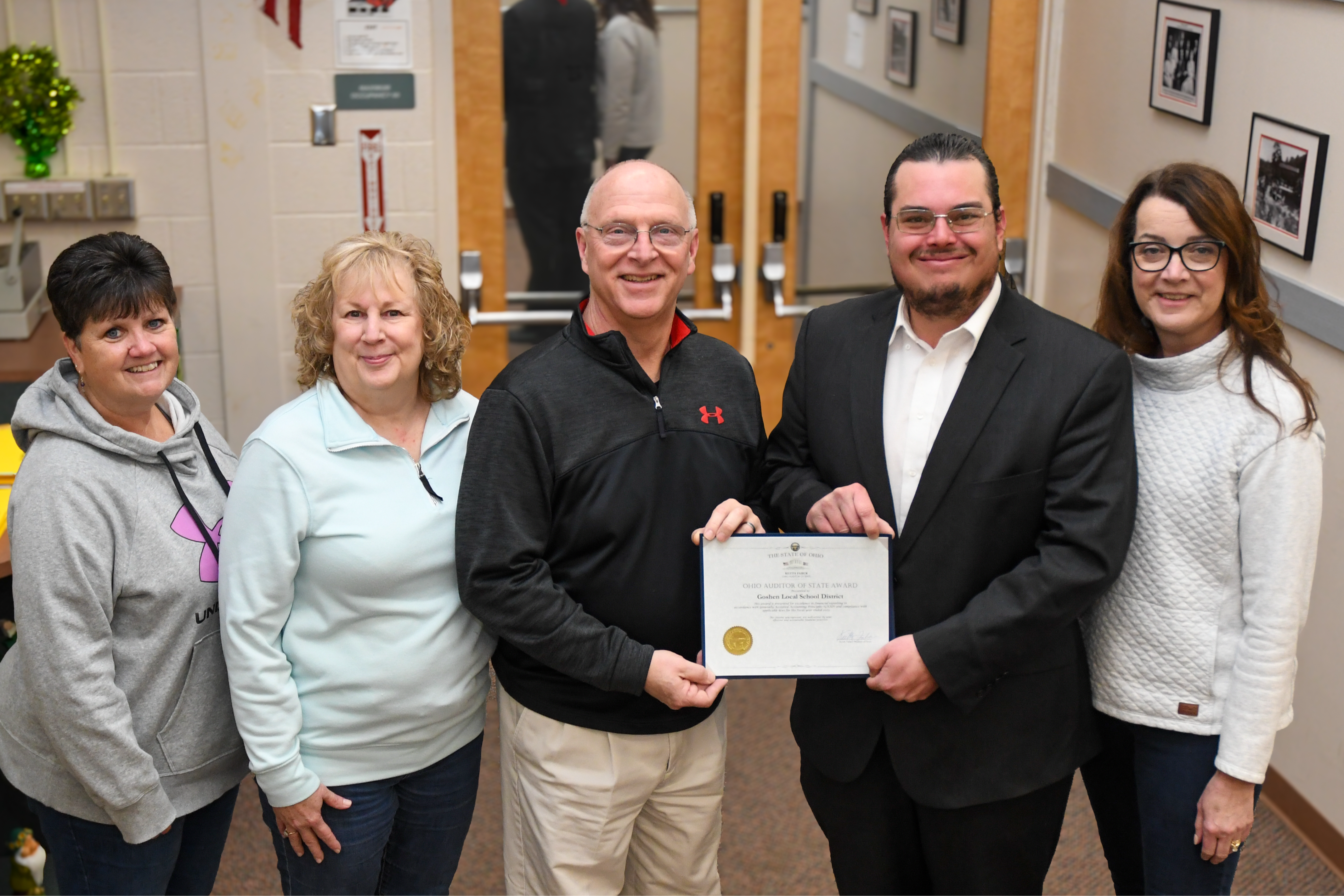 Staff members holding certificate