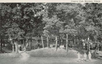 black and white photos of building partially obscured by copse of trees