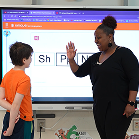 teacher high five with student