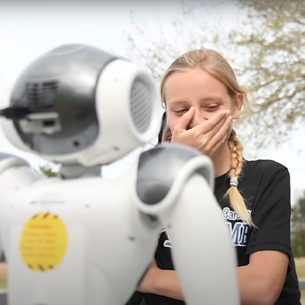 student laughing at robot
