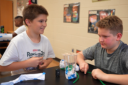 two boys during egg drop challenge at STEAM camp 2023