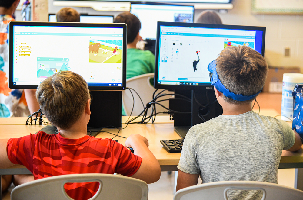 two boys working at computers