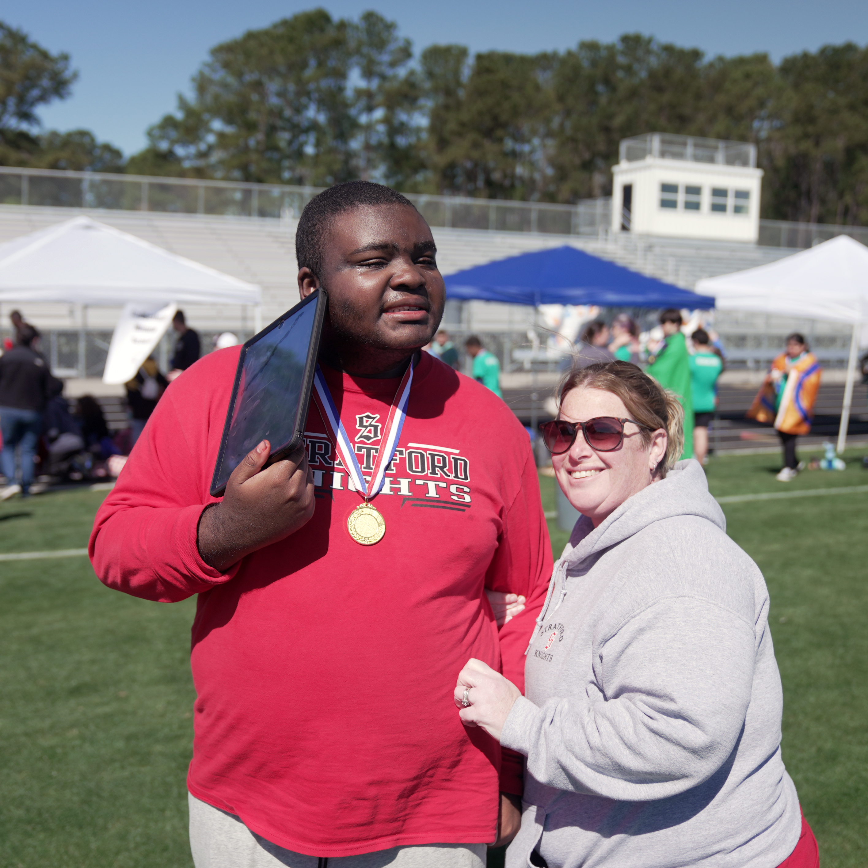 student posing  with medal 