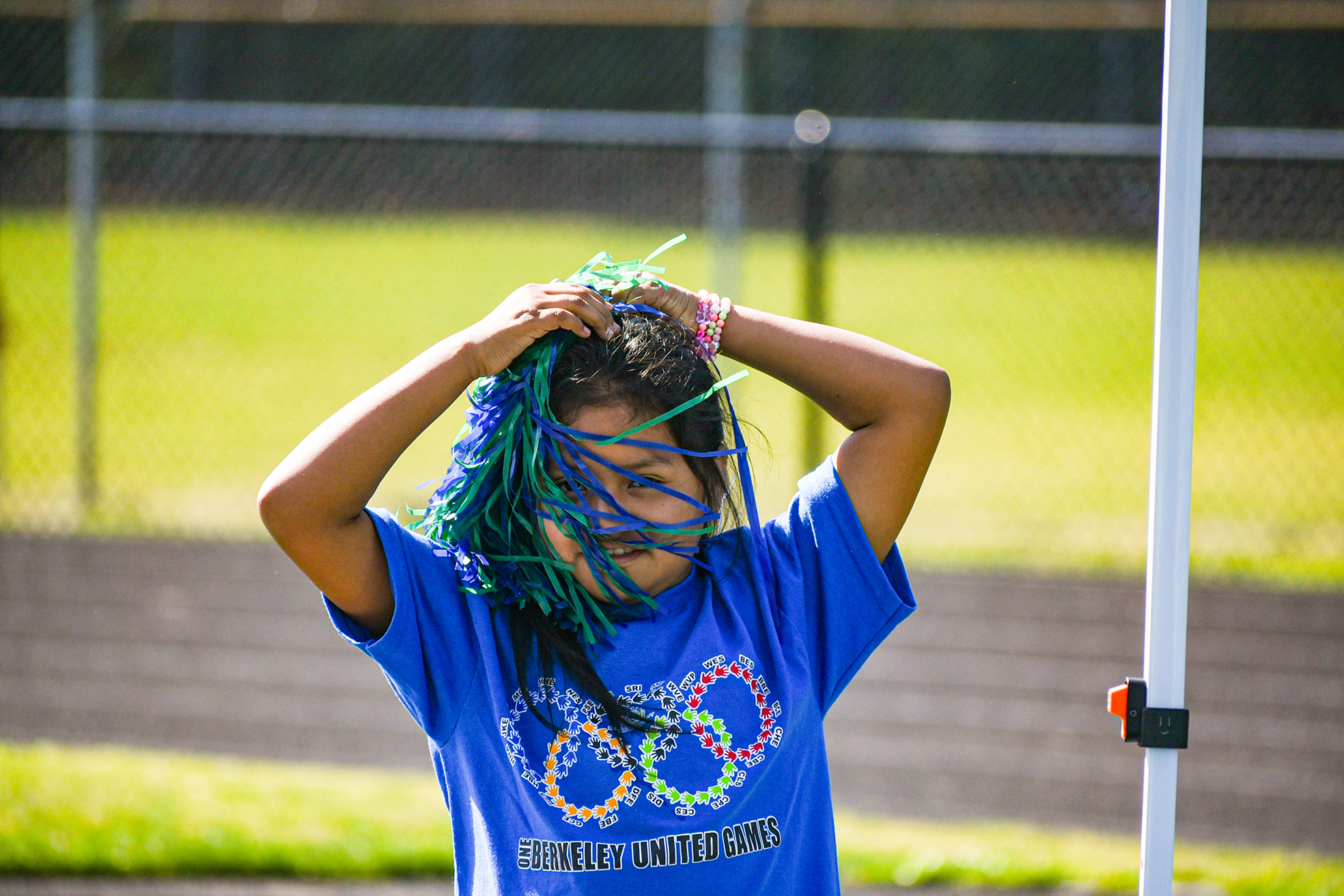 girl fastening pom pom to her hair
