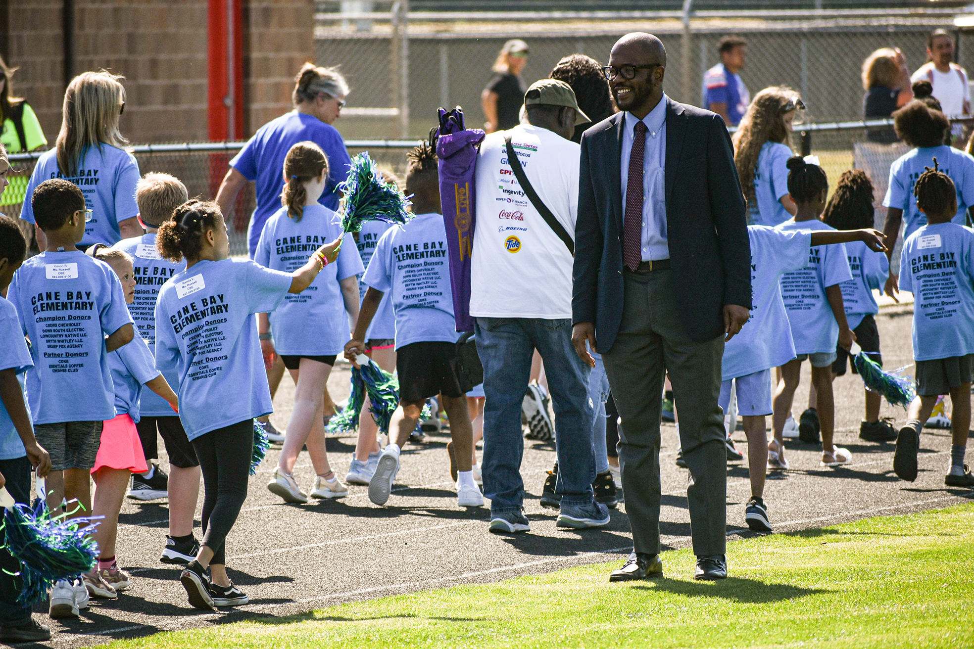 students and staff in parade with dr. dixon