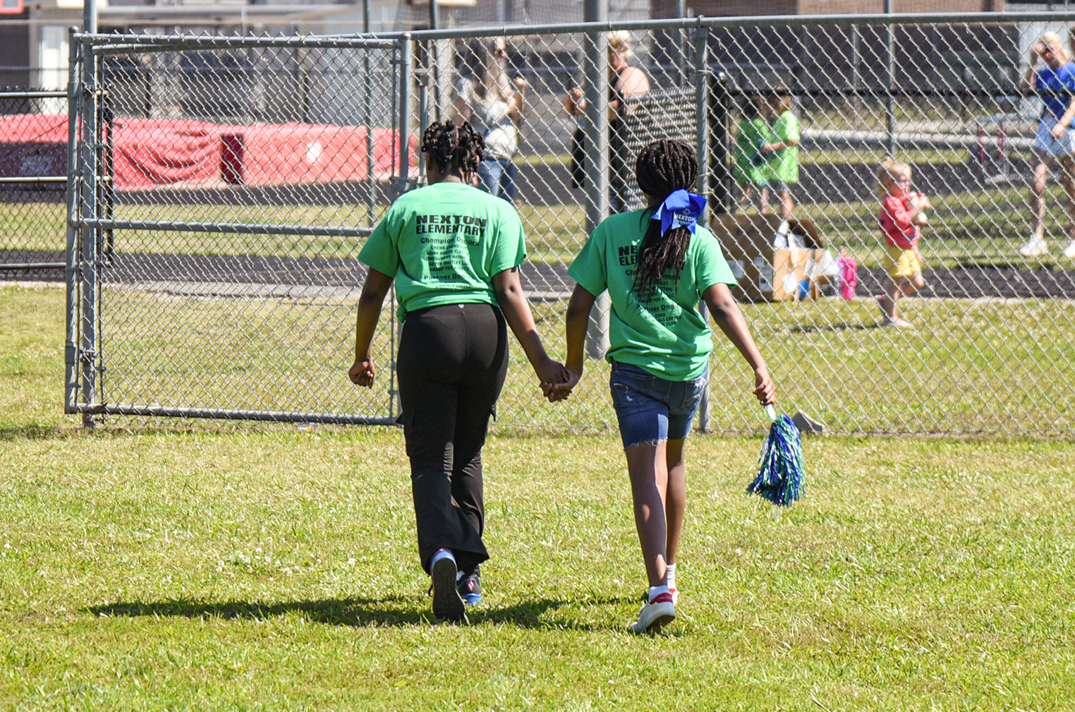 two students walking  hand in hand