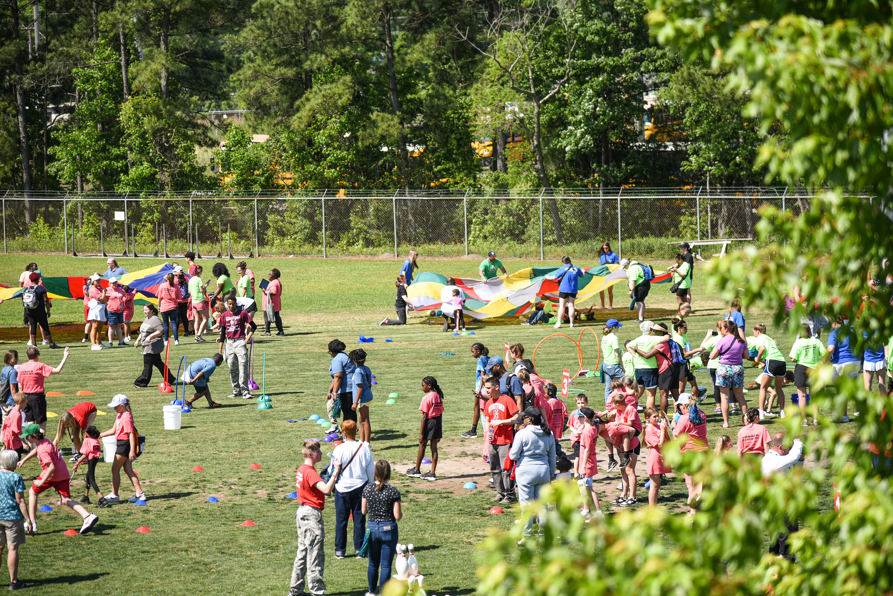 wide view of back field with games going on