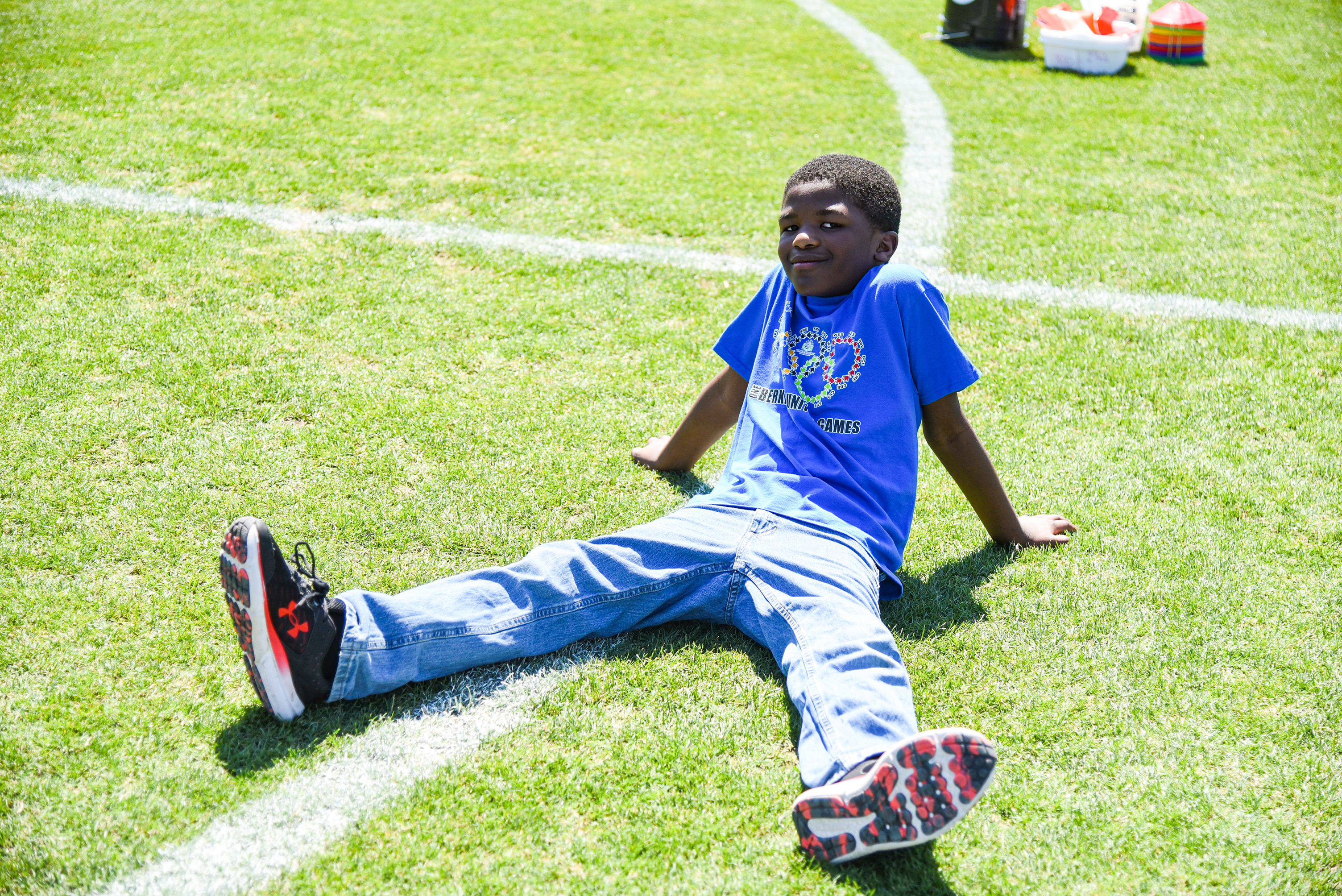 SRI child sitting on grass