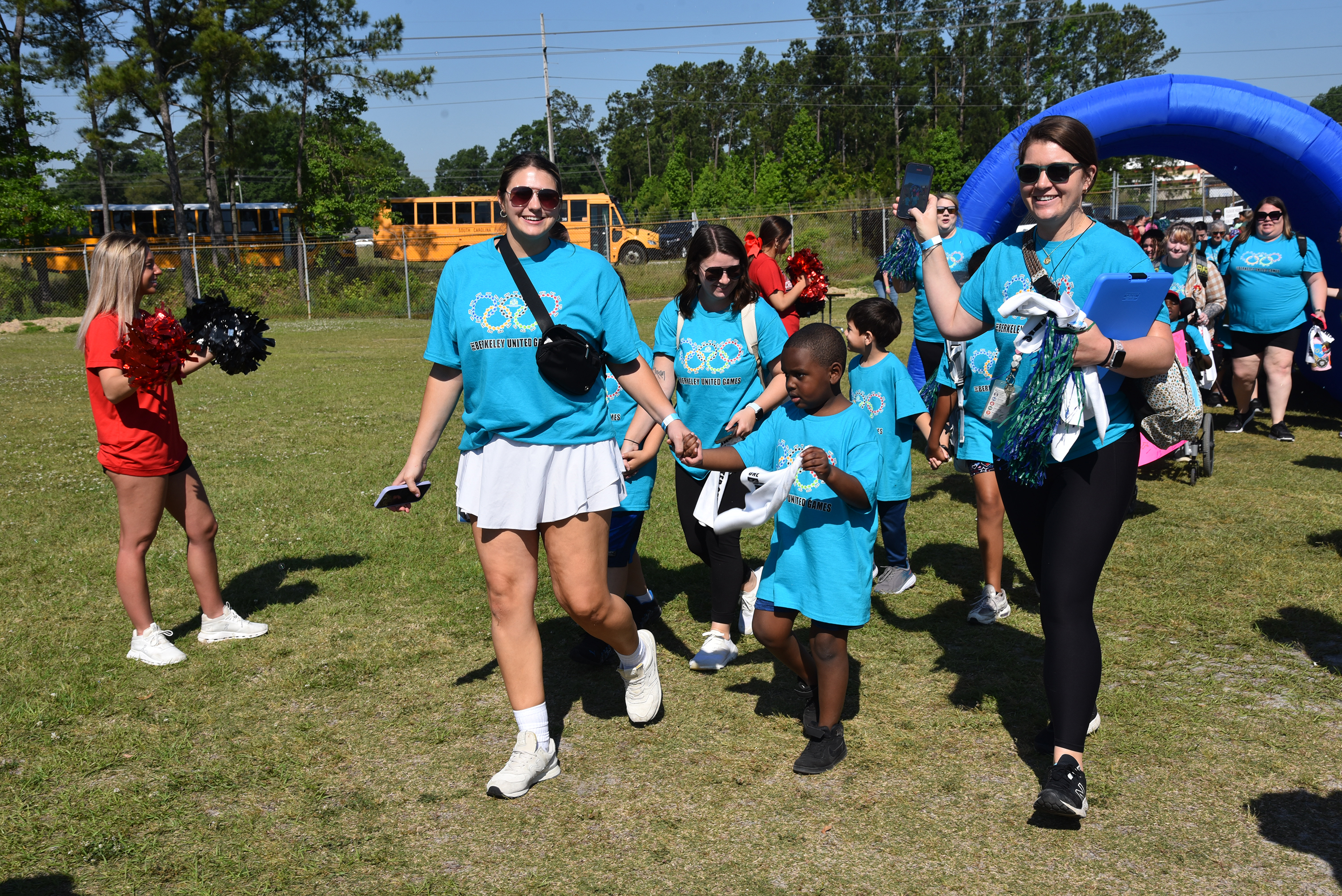 group of students and staff approaching field