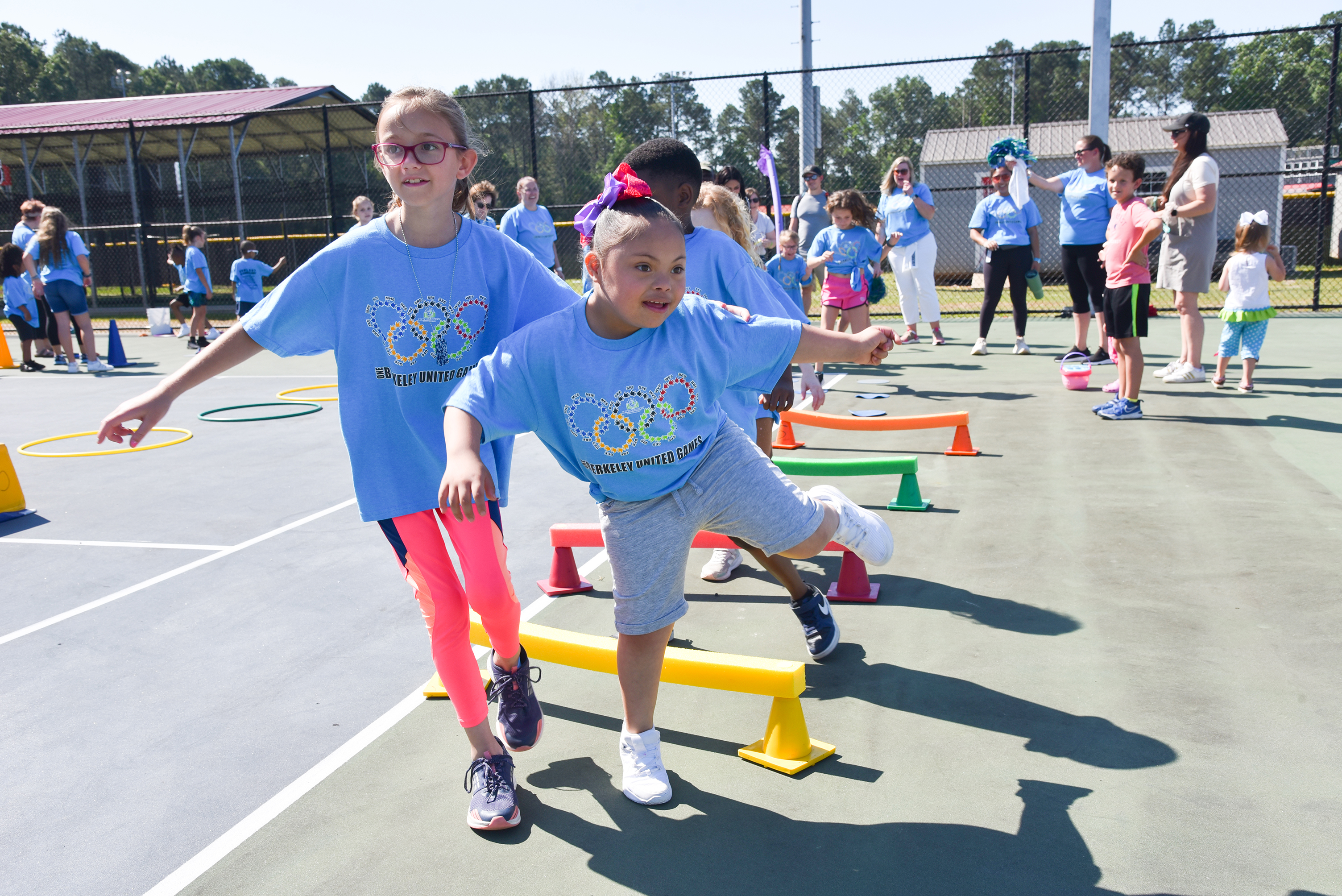 students in periwinkle shirts playing games