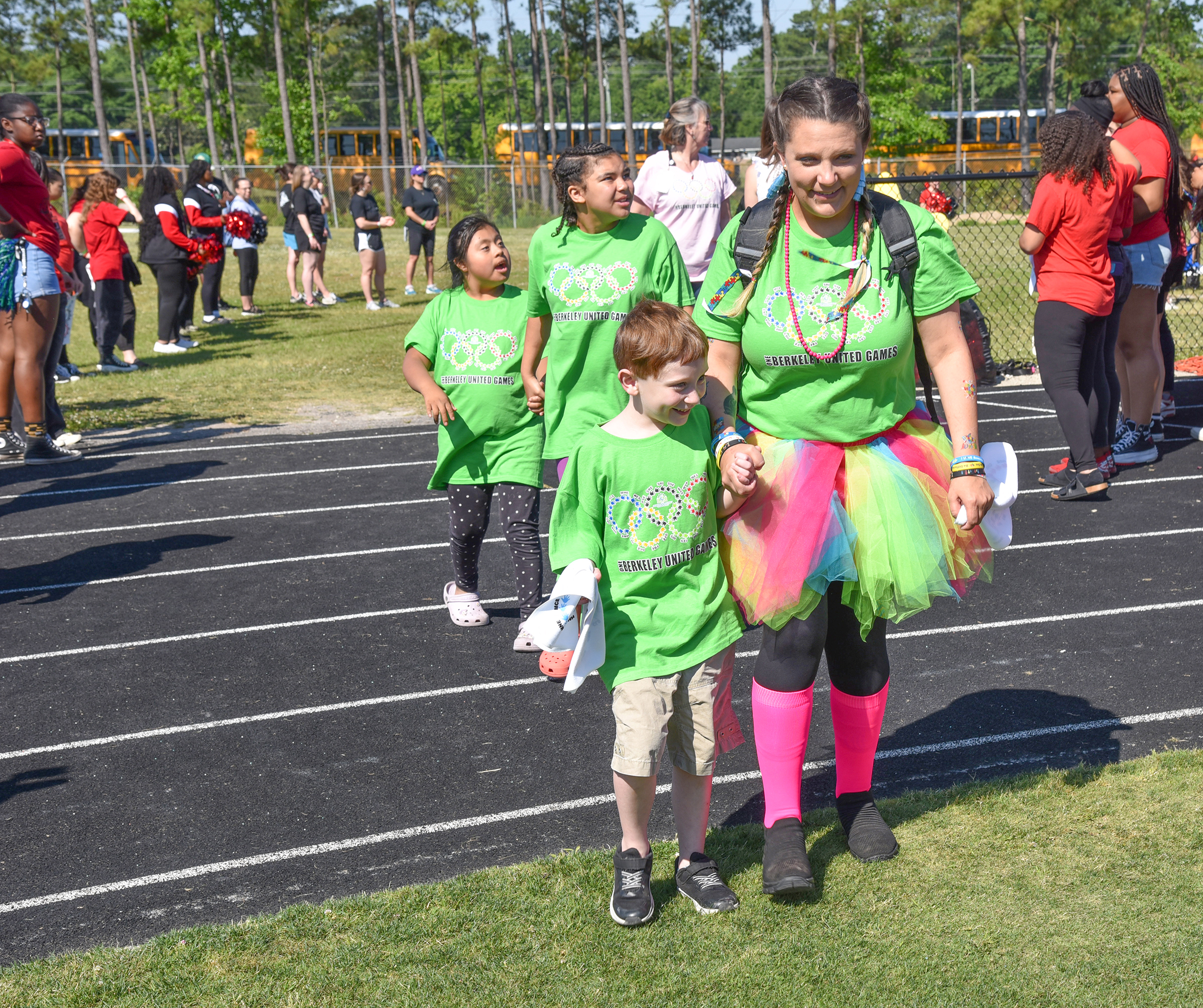 students in lime gree shirts on track