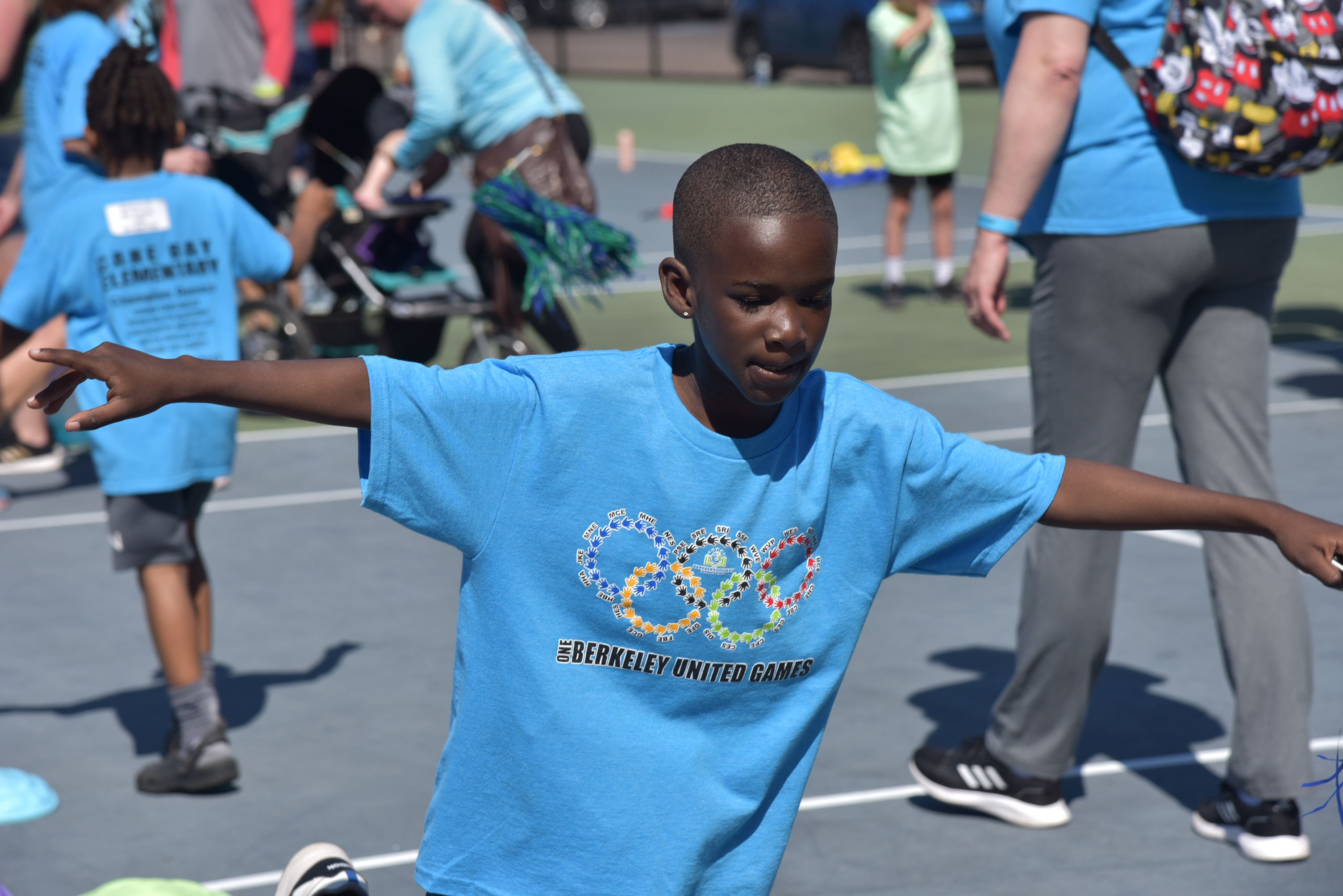 students in blue shirts playing games