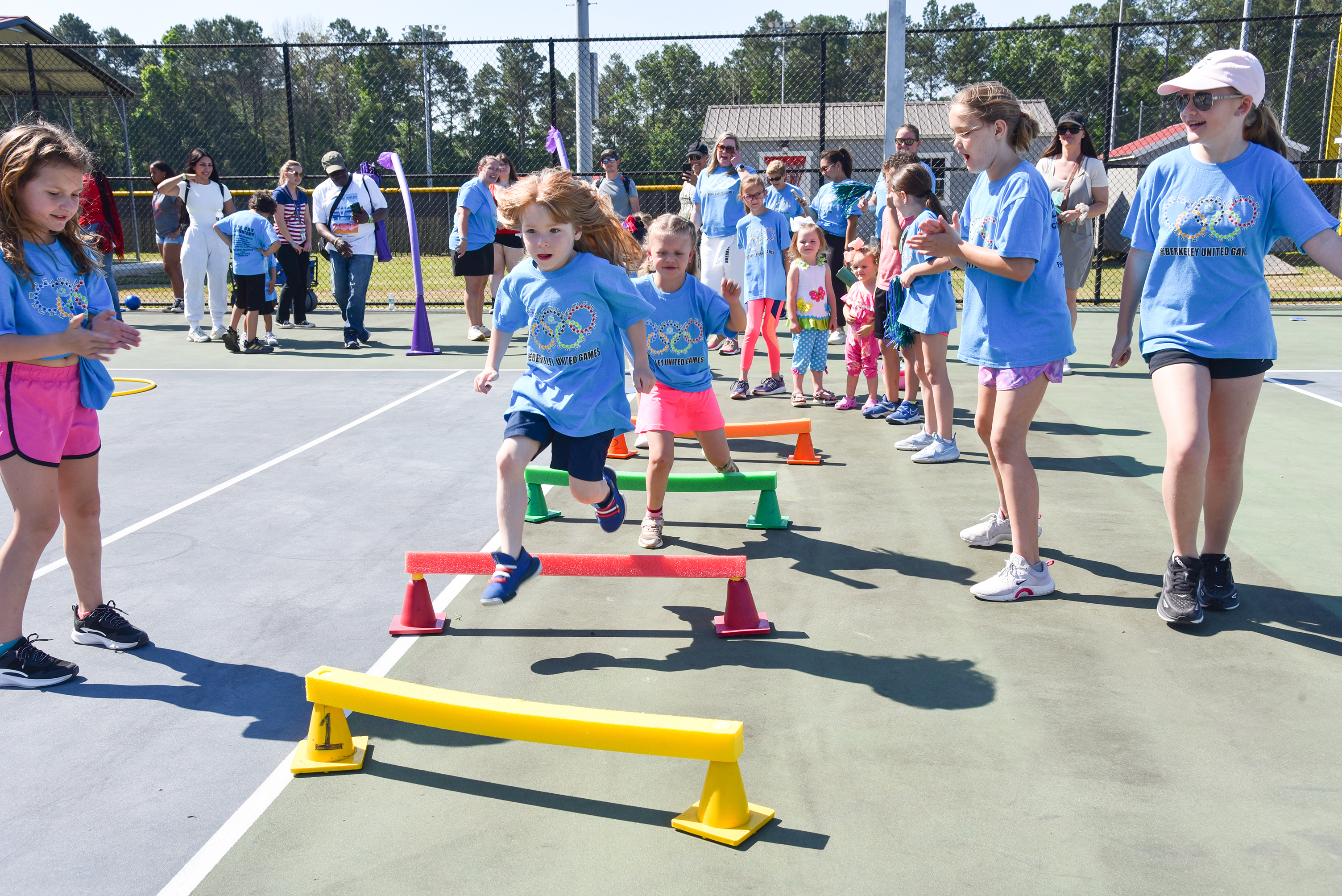 students in periwinkle shirts playing games