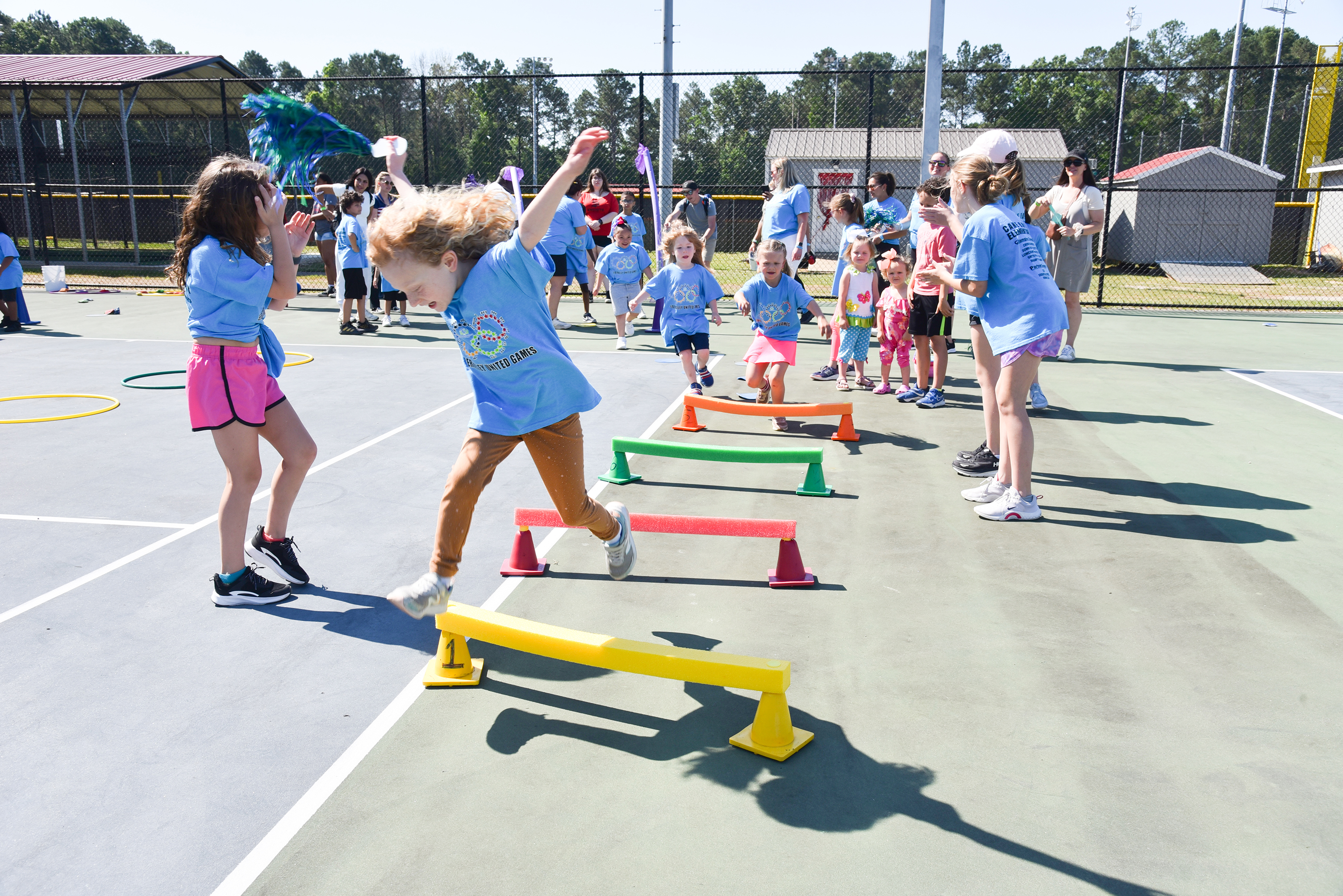 students in periwinkle shirts playing games