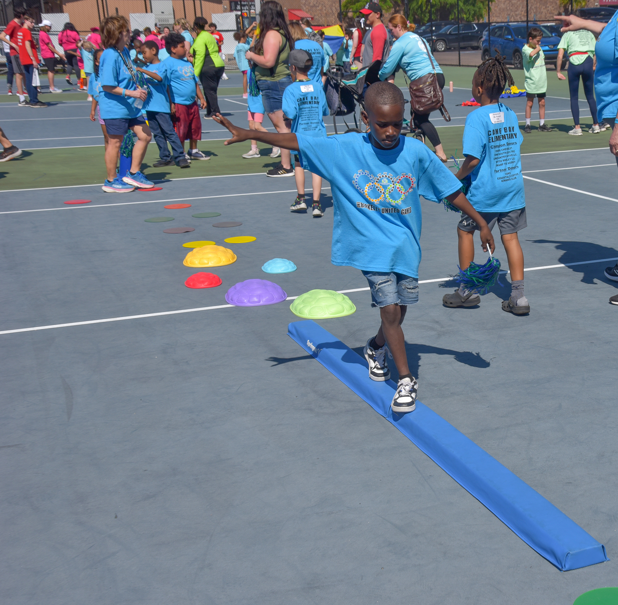 students in blue shirts playing games