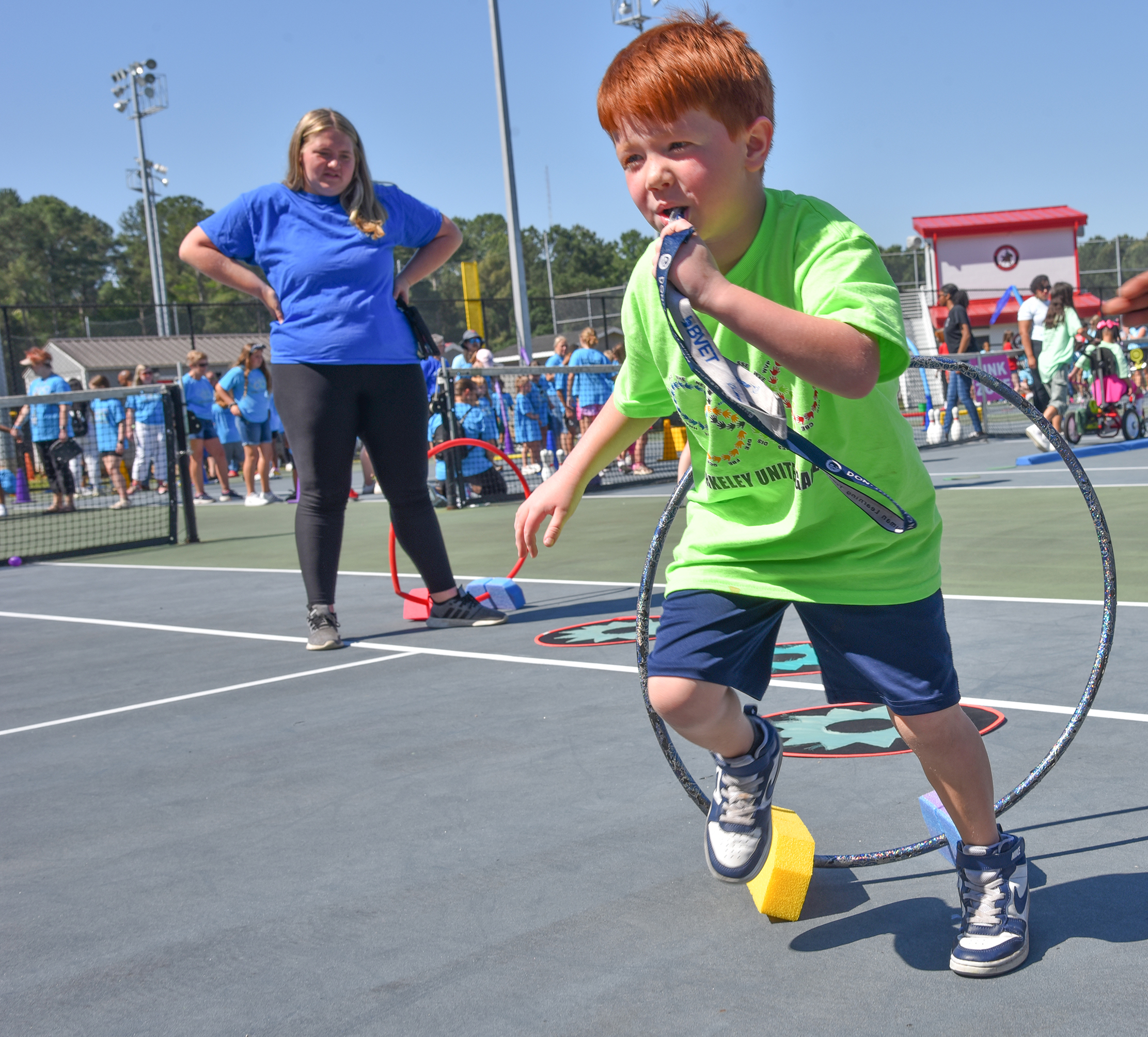 red head student playing with hoop