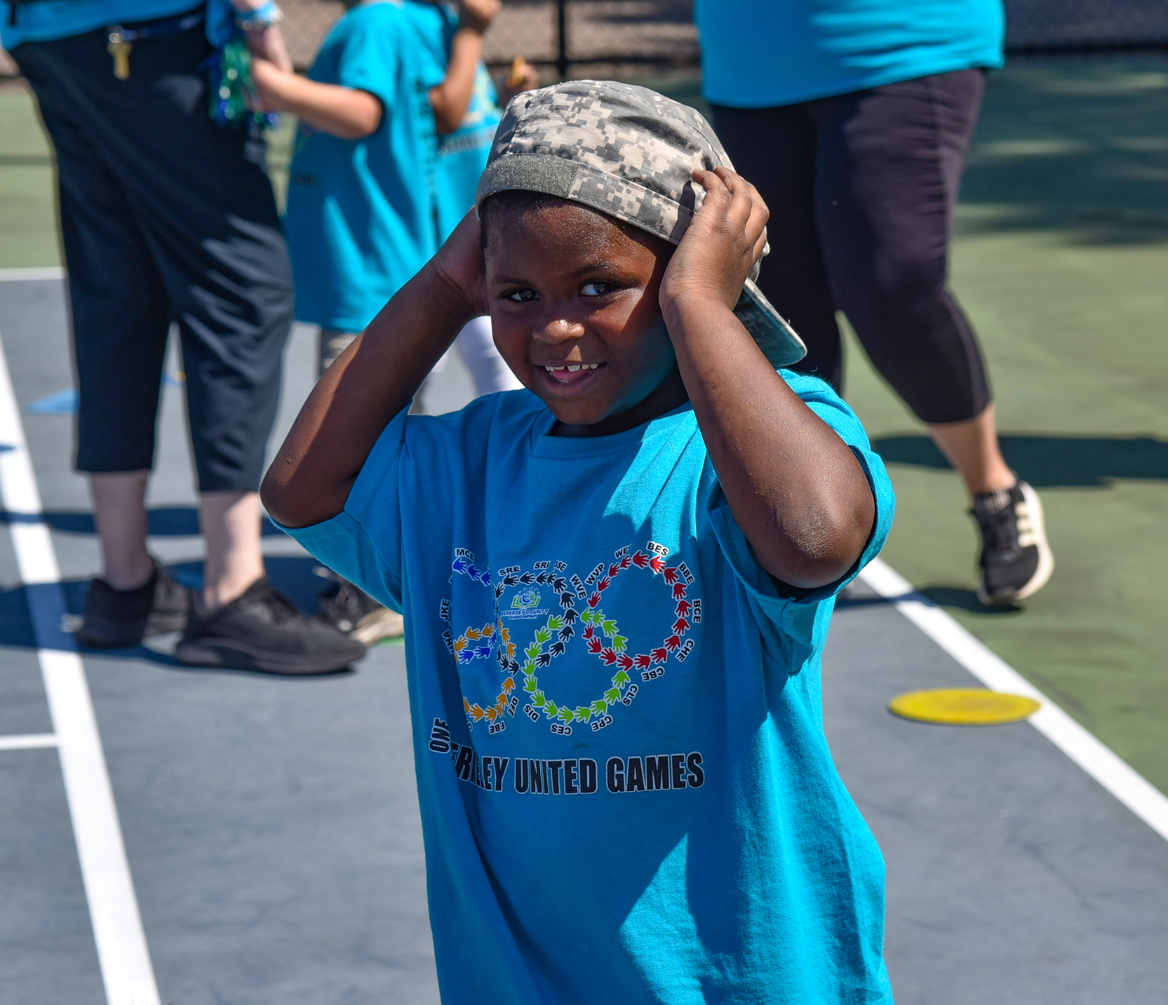 student in blue shirt smiling at camera