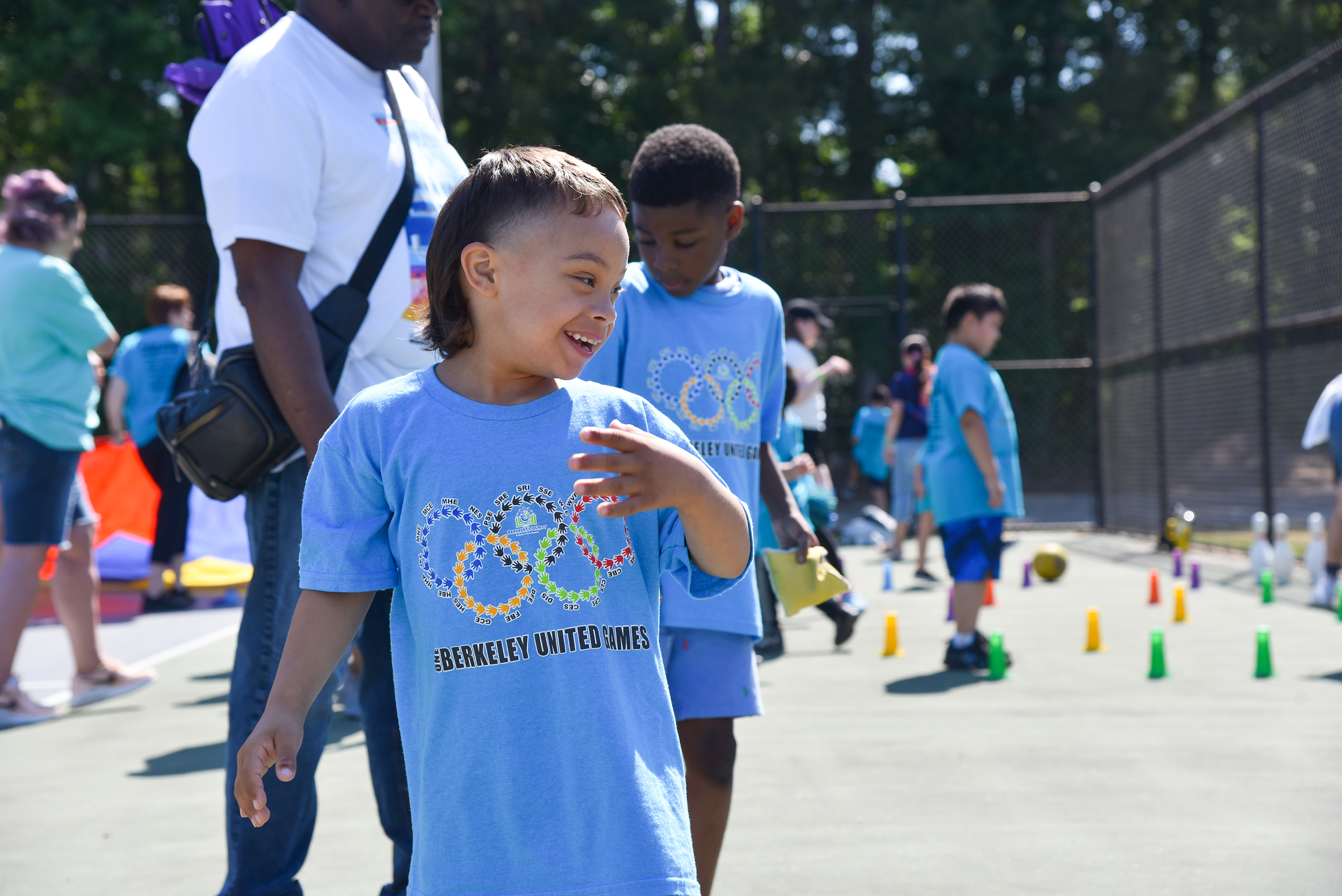 students in periwinkle shirts laying games