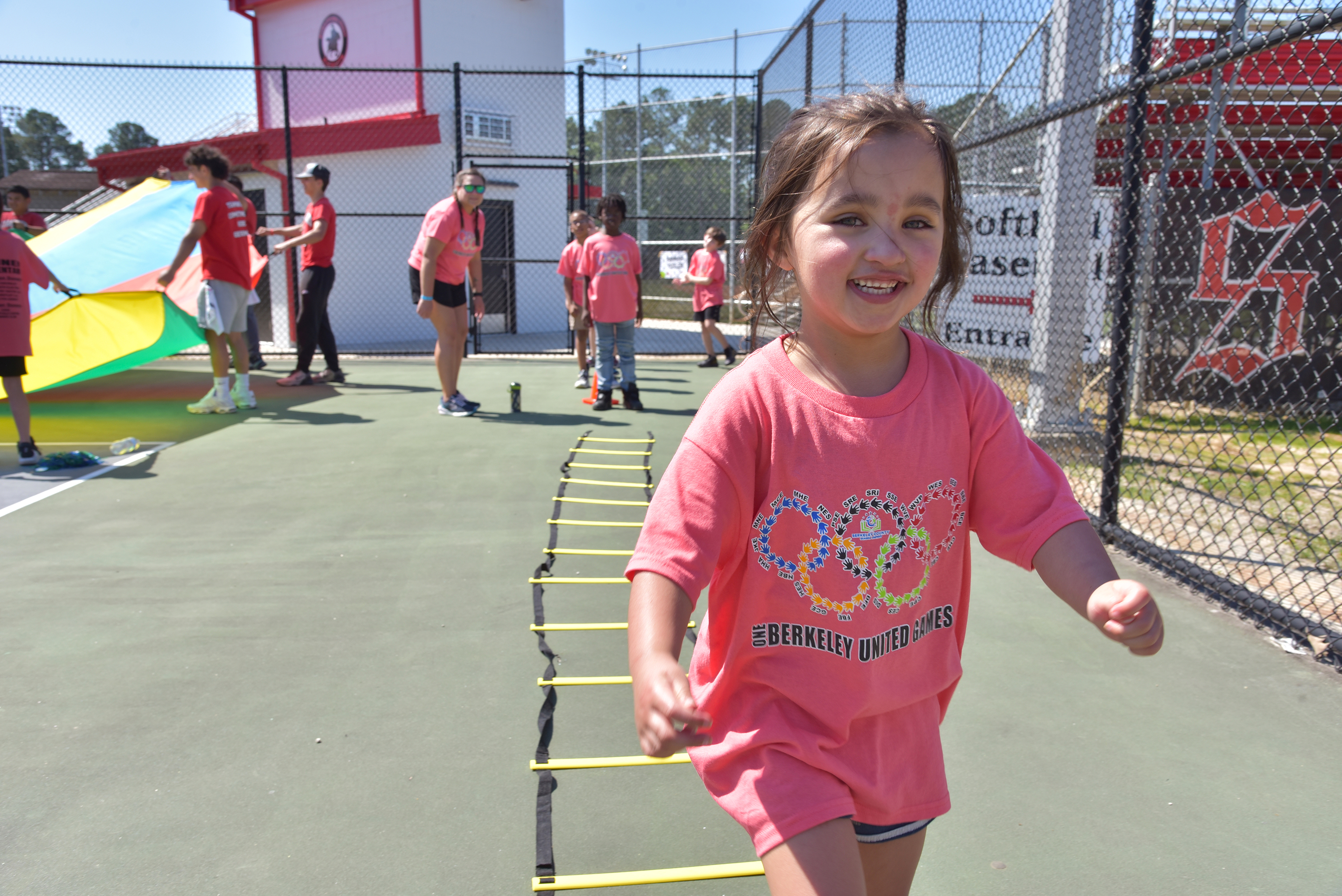 girl in pink shirt smiling at camera