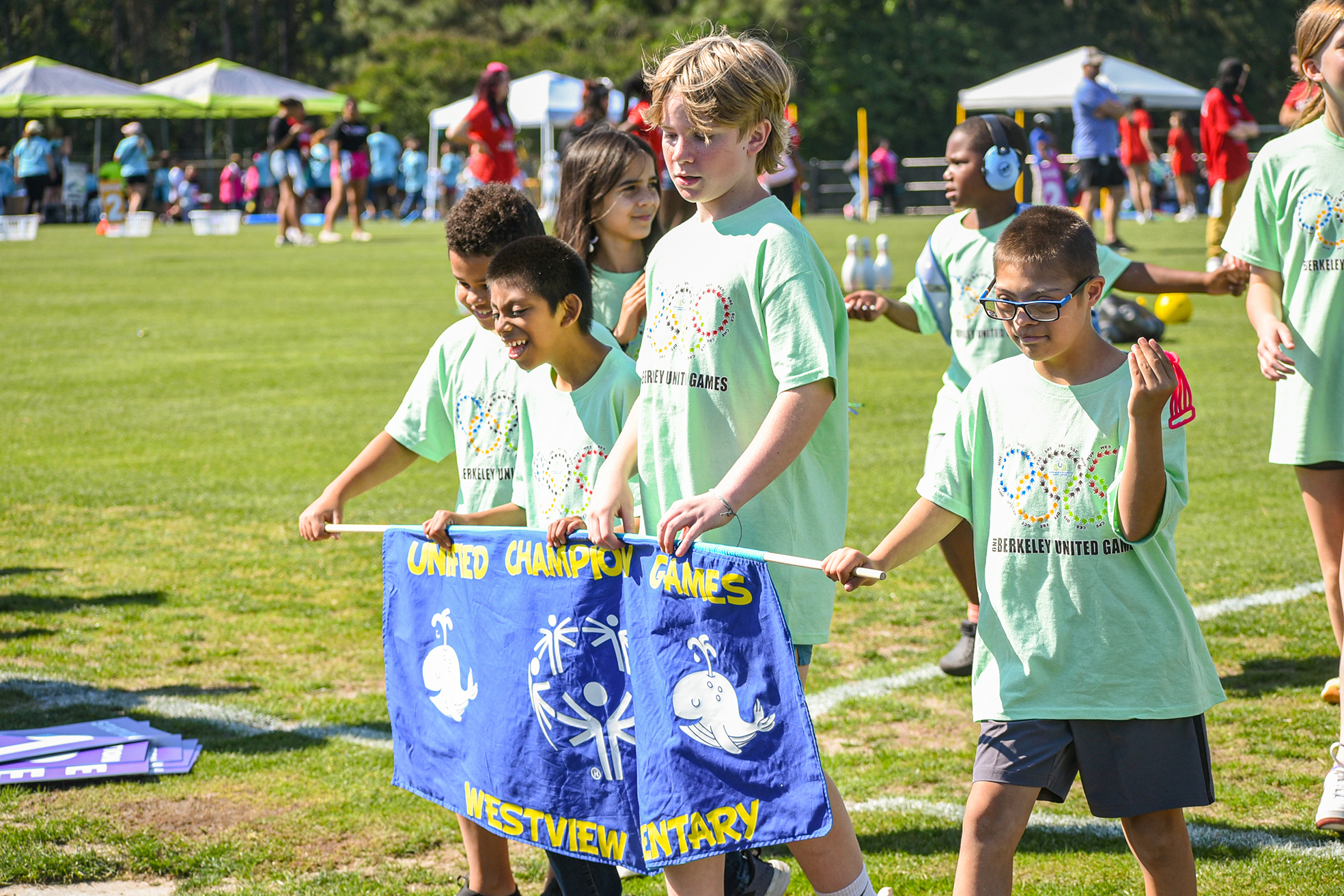 WVE kids with banner