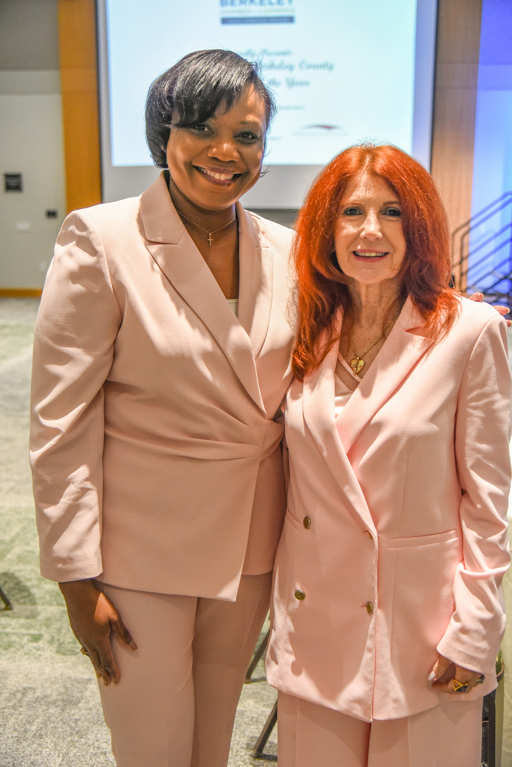 glenda and chamber member wearing matching pantsuits