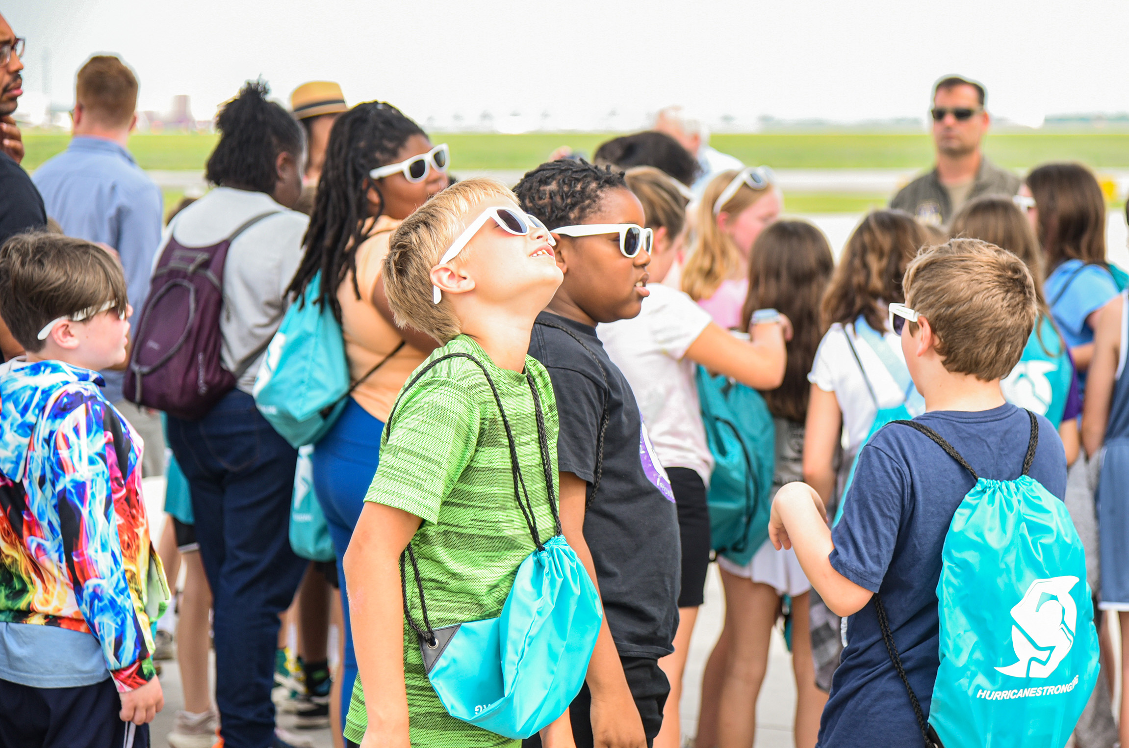 students gathering outside plane