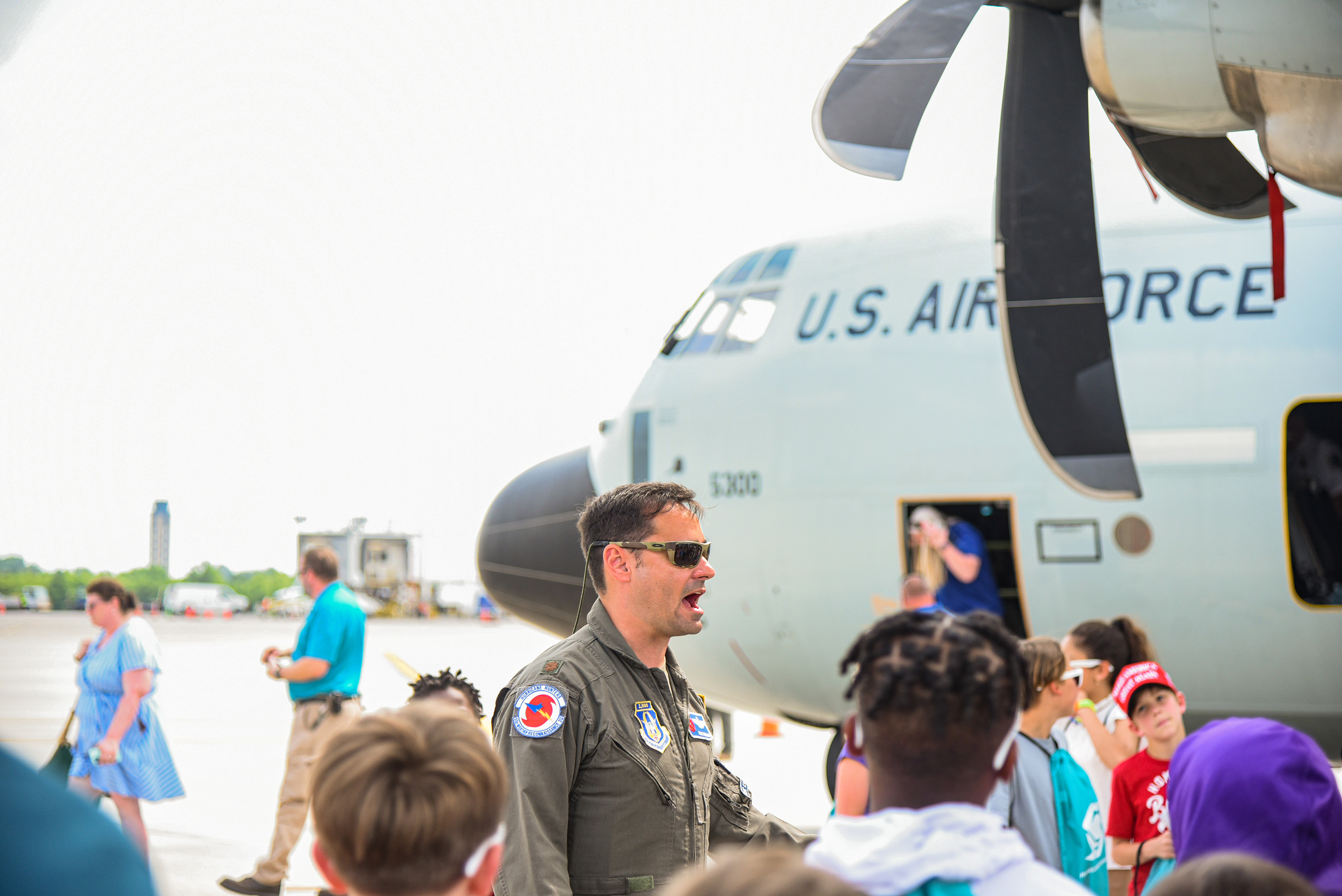 students gathering under plane's wing