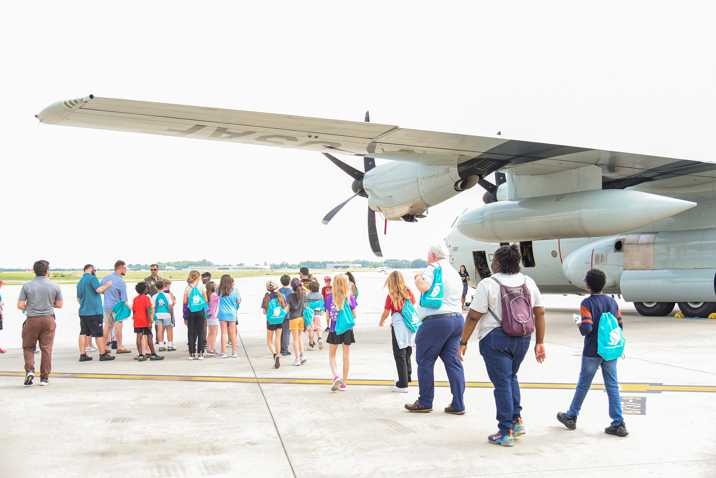 students gathering outside plane