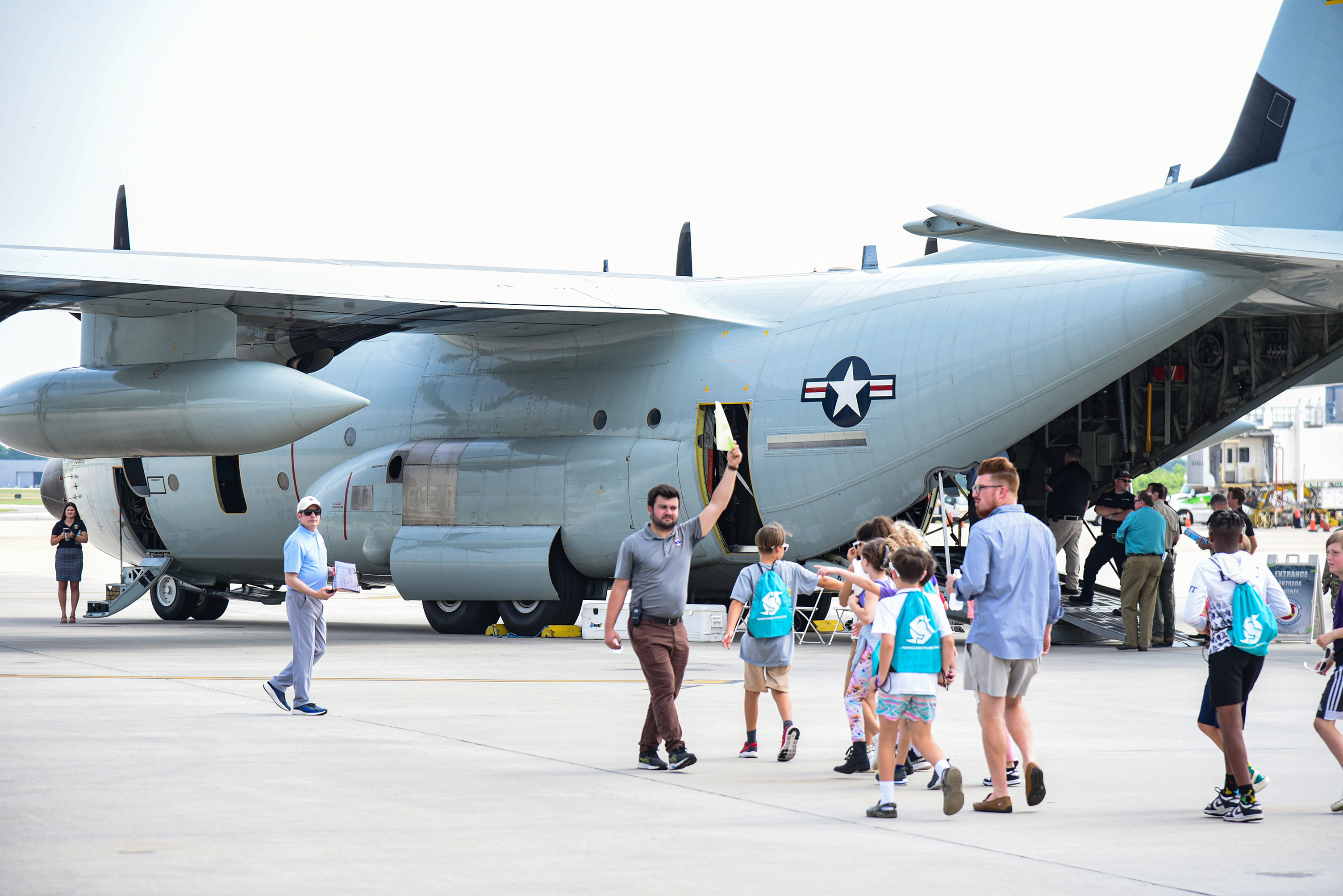 students gathering outside plane