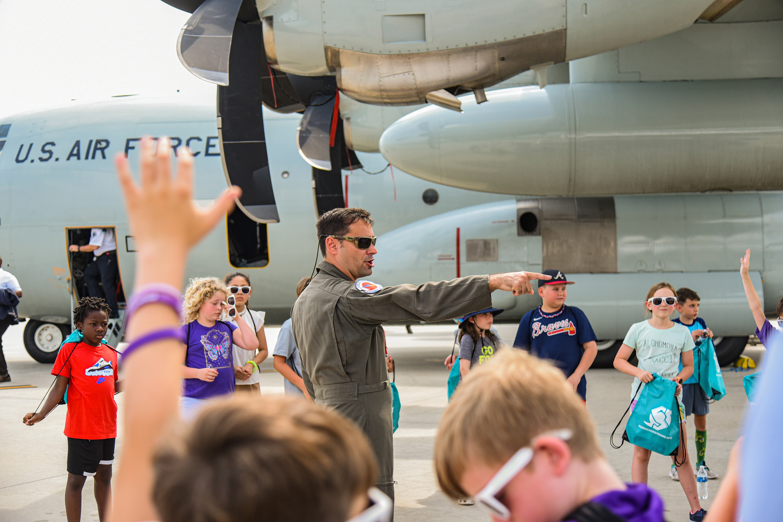 students gathering under plane's wing