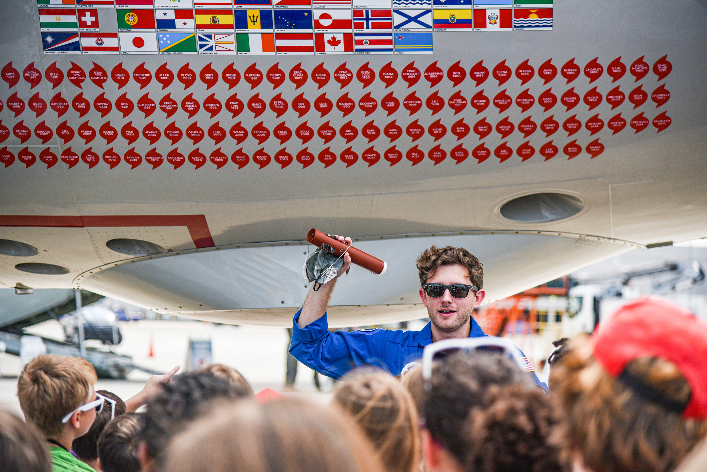 NOAA rep talking to kids in front of plane